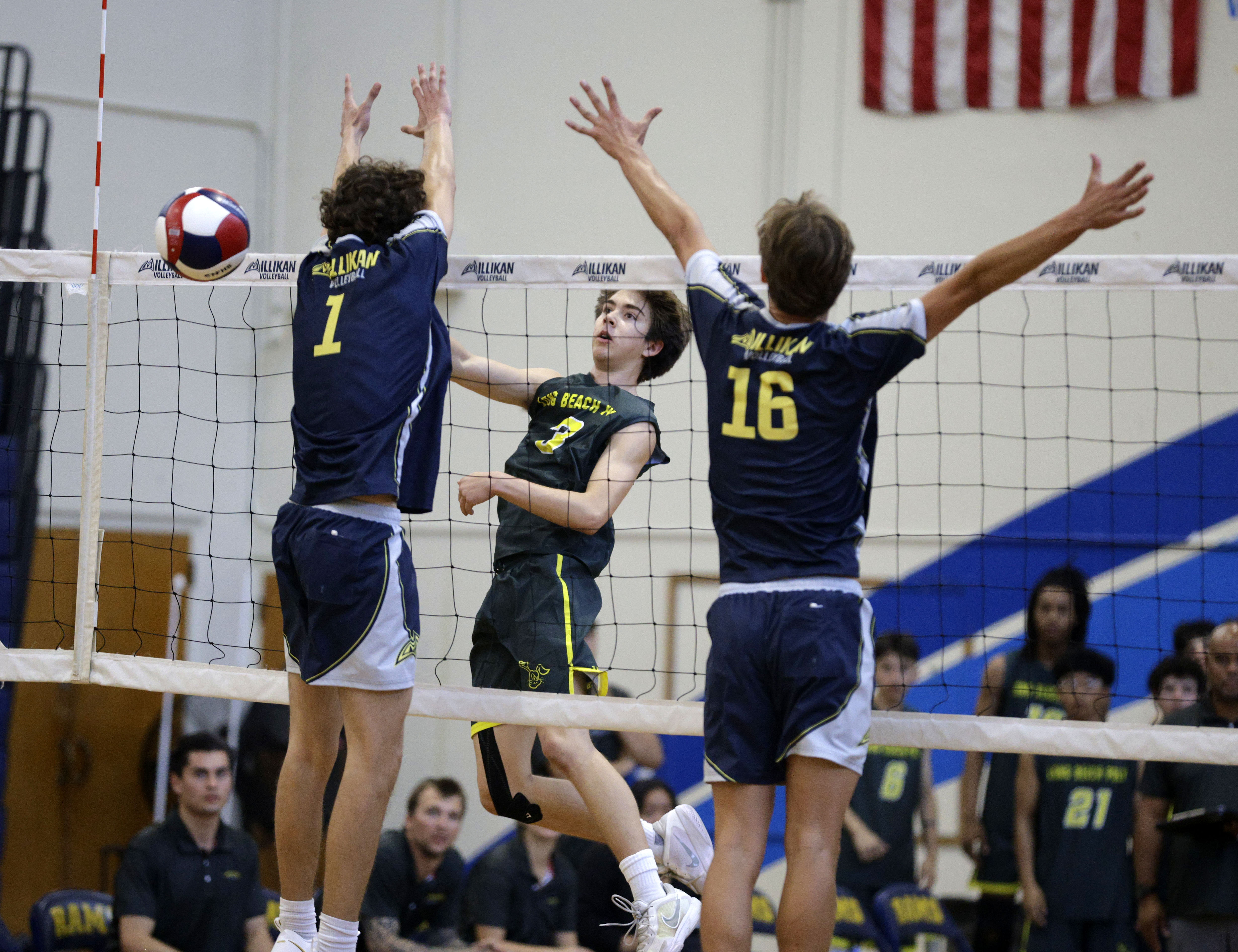 Long Beach Poly’s Nicholas Frank (3) hits the ball past...