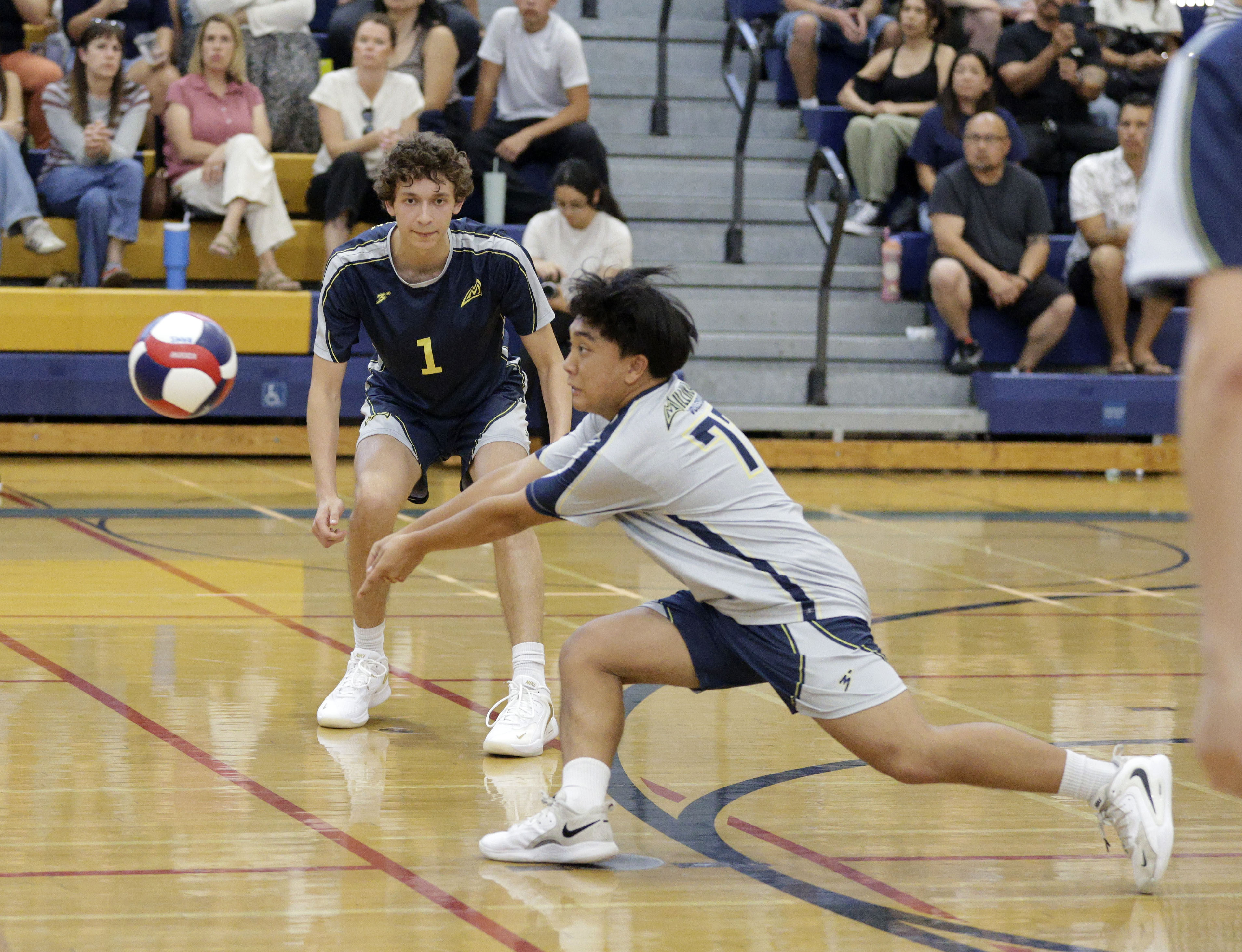Millikan’s Rai Flores (77) returns the serve as the Rams...