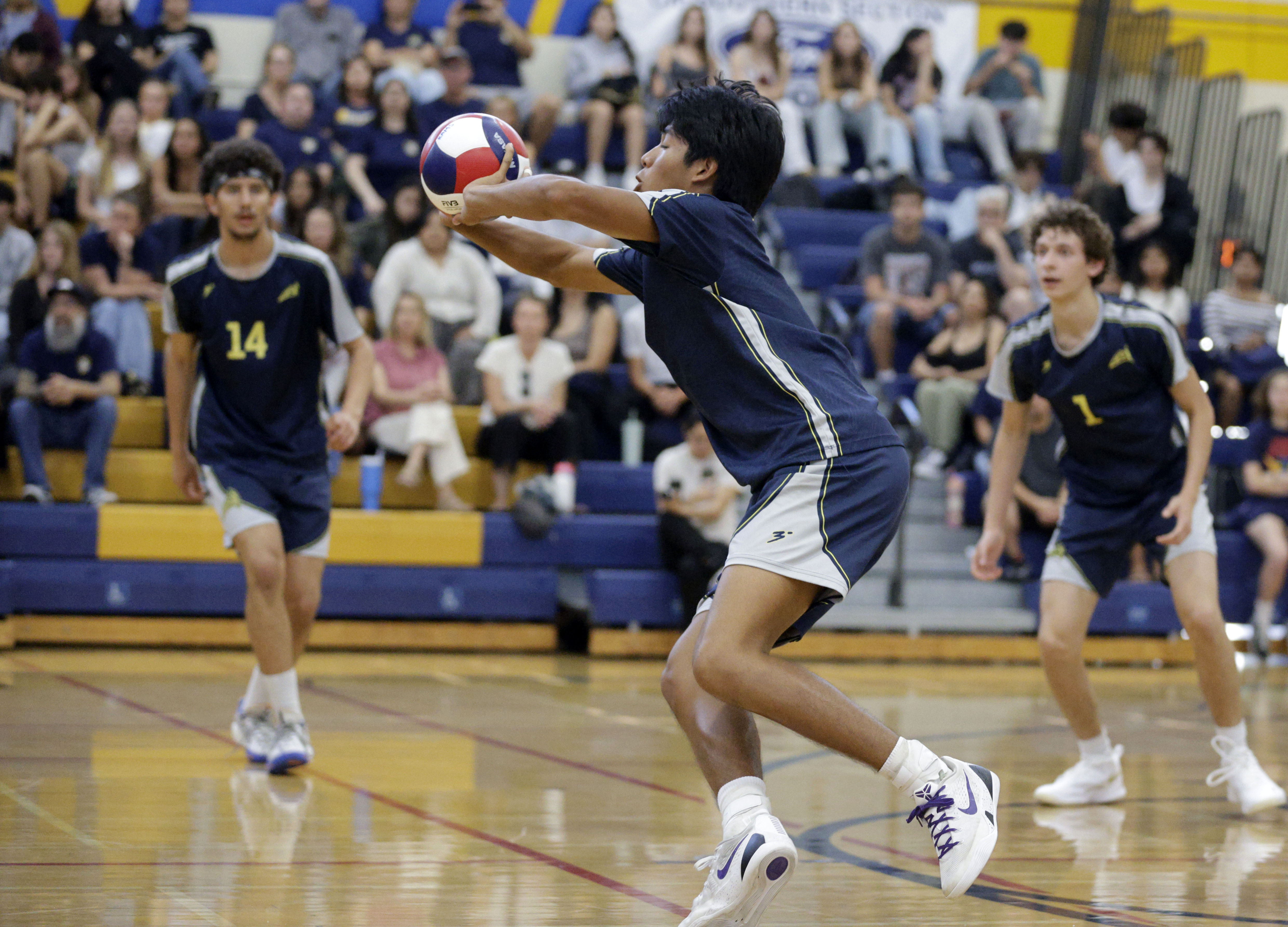 Millikan’s Kobe Magdael (4) returns the serve as the Rams...