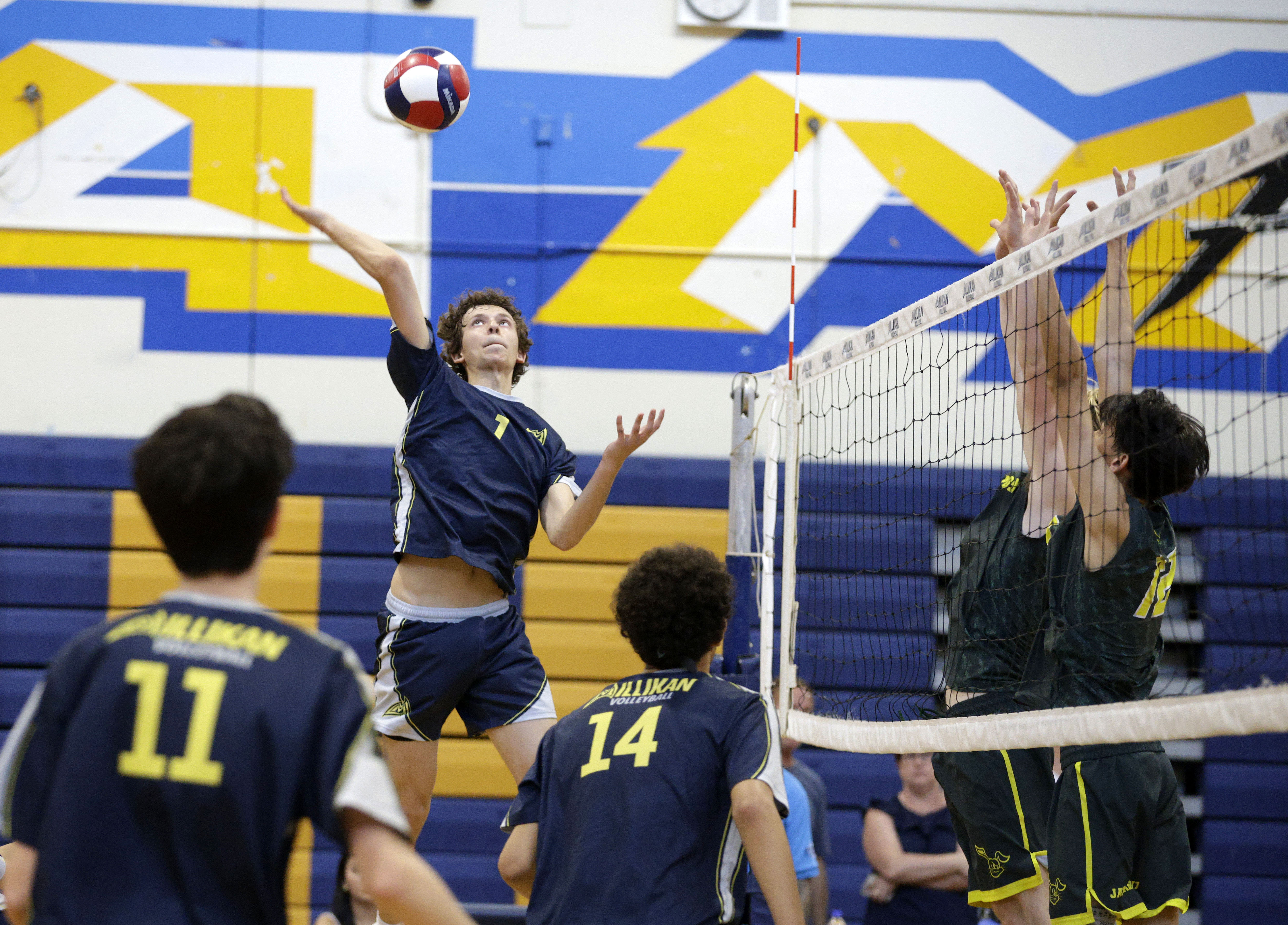 Millikan’s Jacob Karkanen (1) goes up for the hit as...