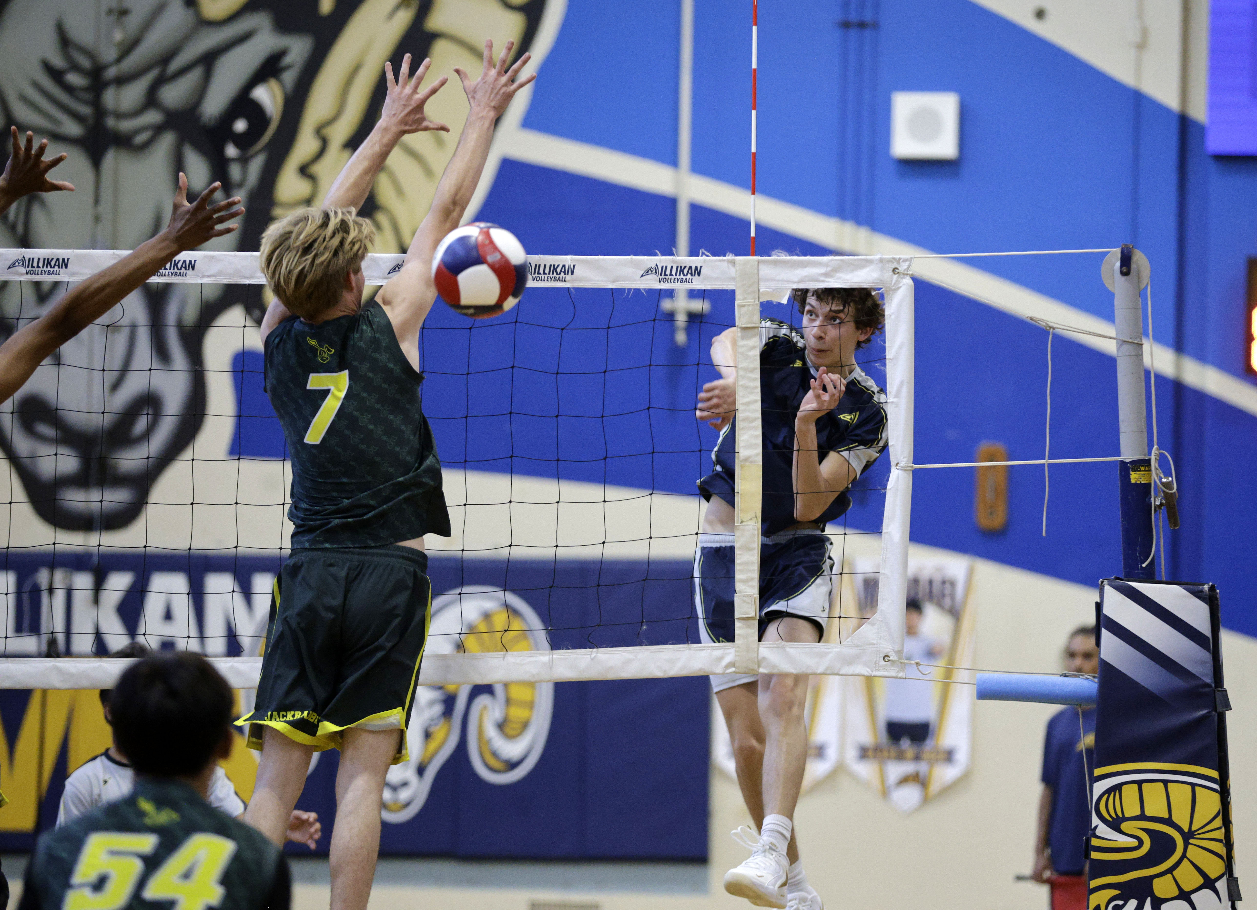 Millikan’s Jacob Karkanen (1) hits the ball past Long Beach...