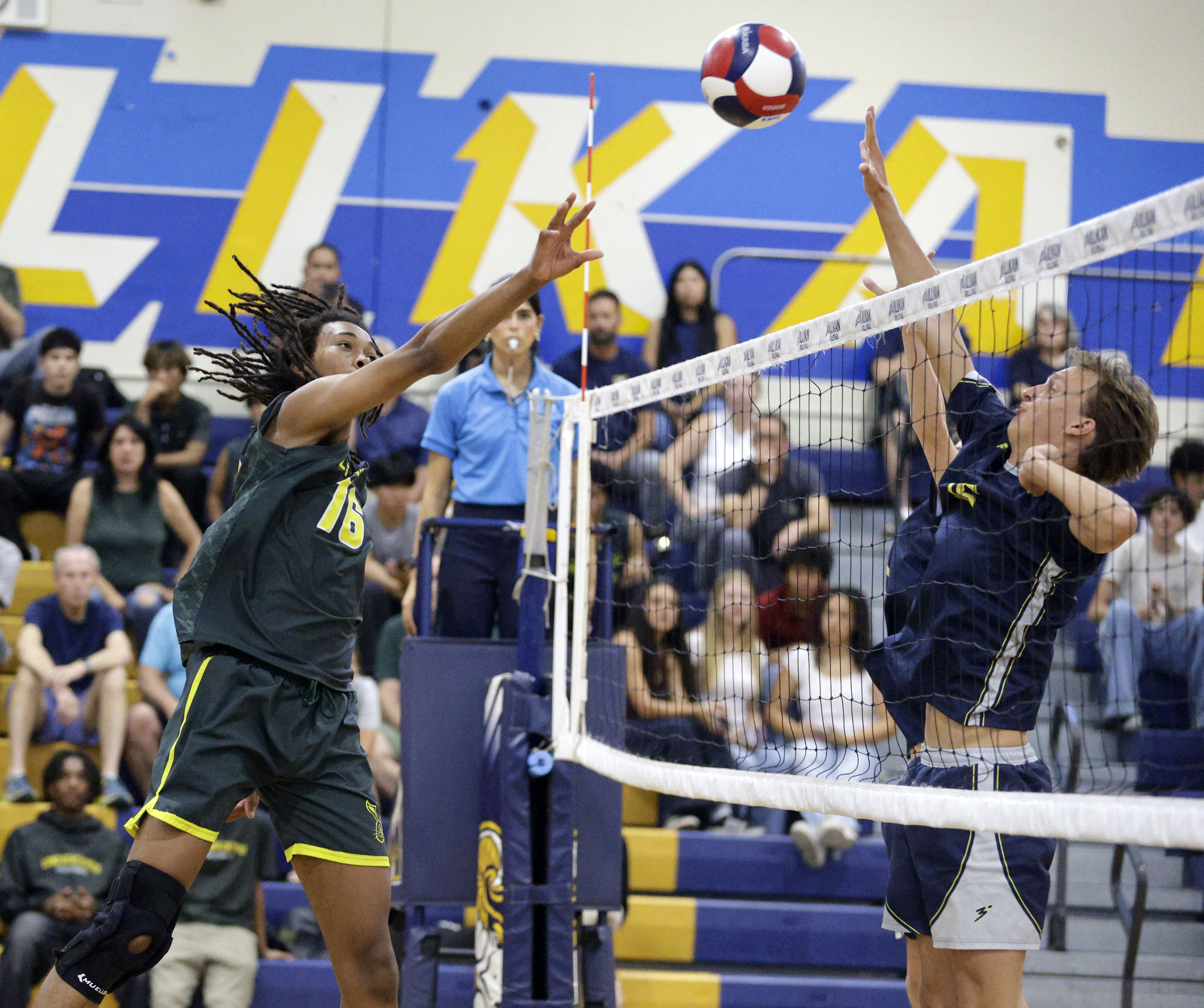 Long Beach Poly’s Josiah Hill (16) hits the ball over...