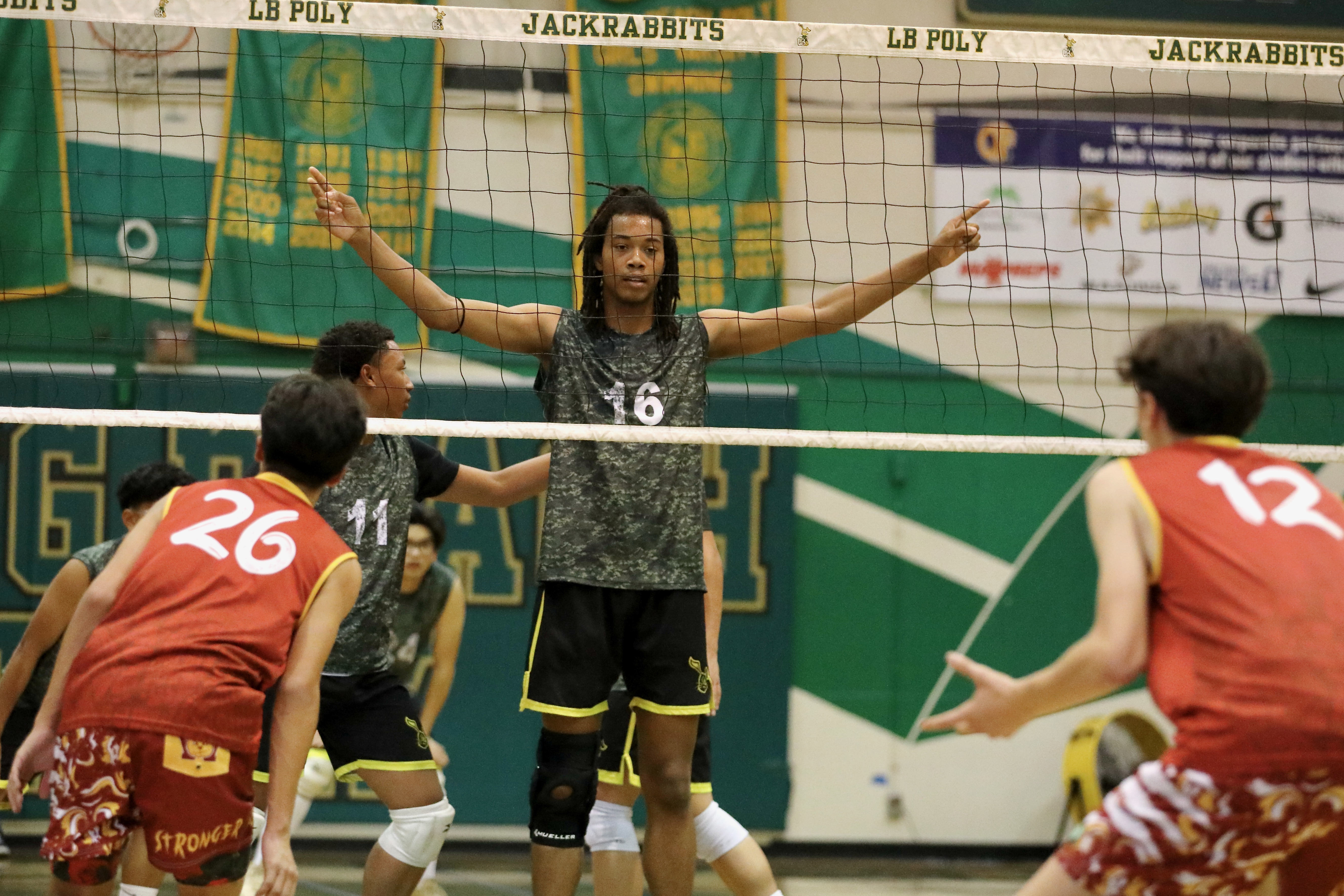 Long Beach Polyâs Josiah Hill signals the offense play in...