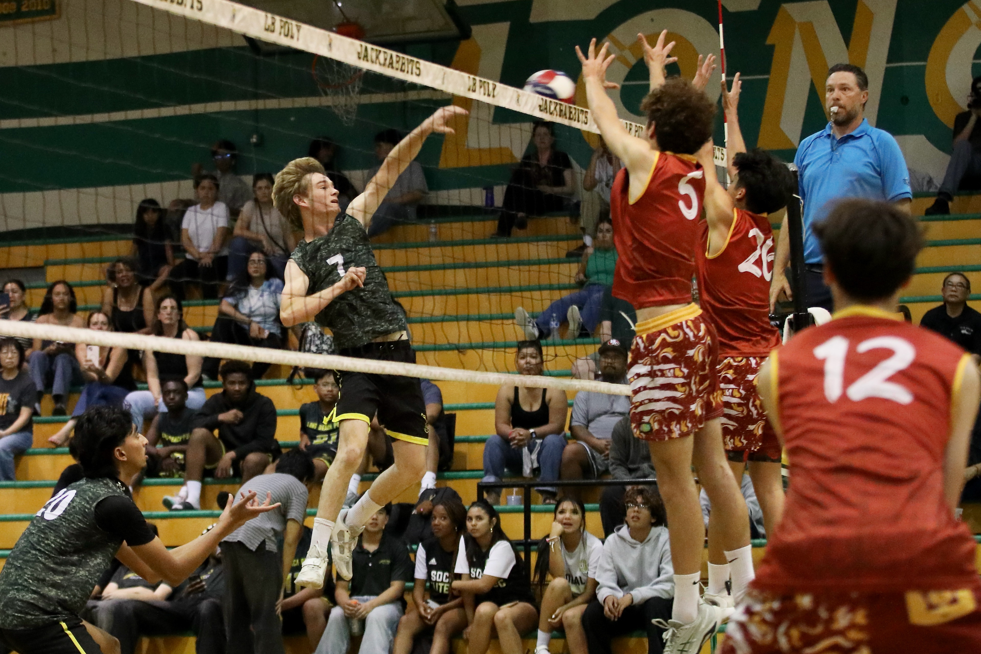 Long Beach Polyâs Wyatt Sheetz scores a point over Wilson...