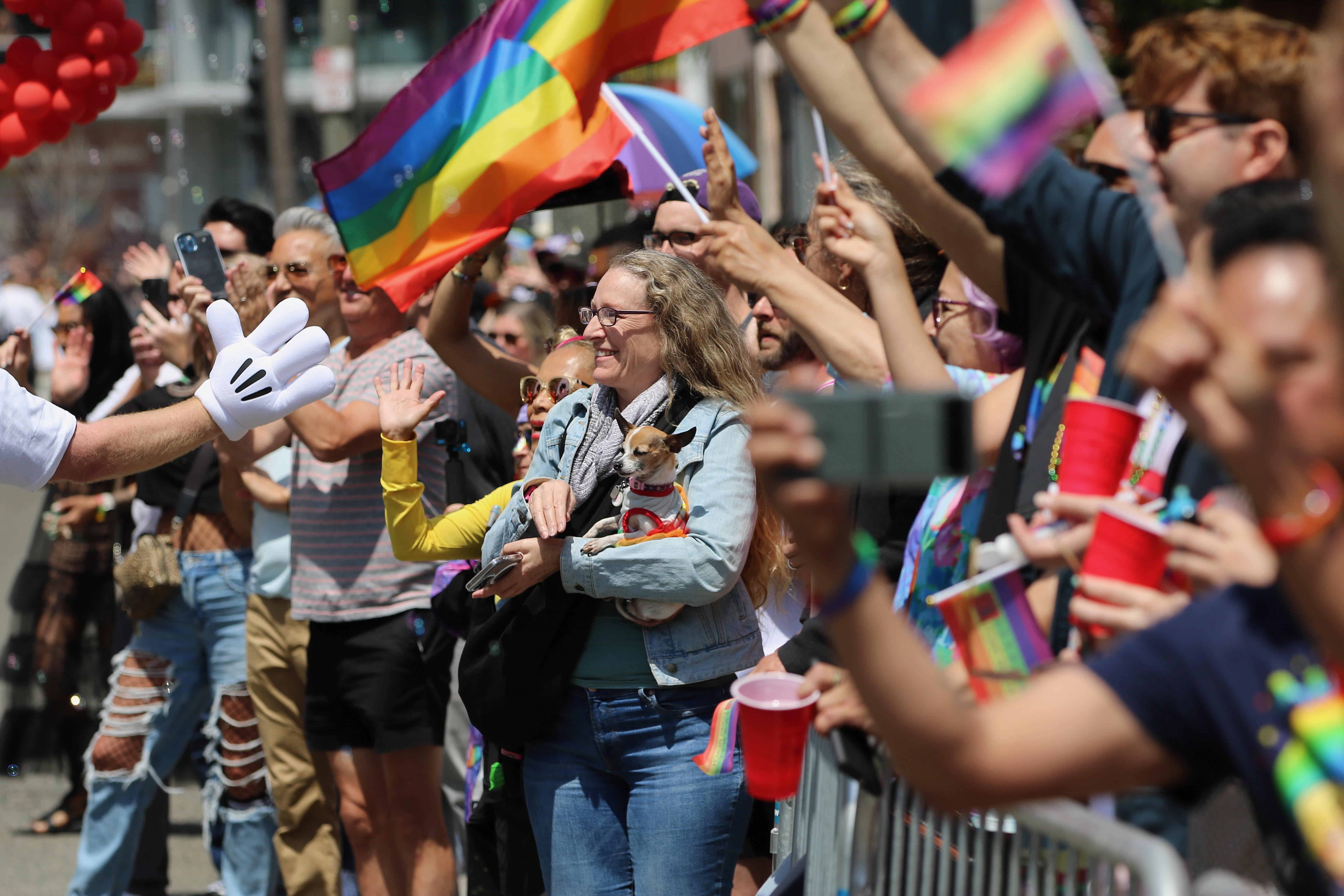 Spectators line the parade route along Ocean Boulevard for the...