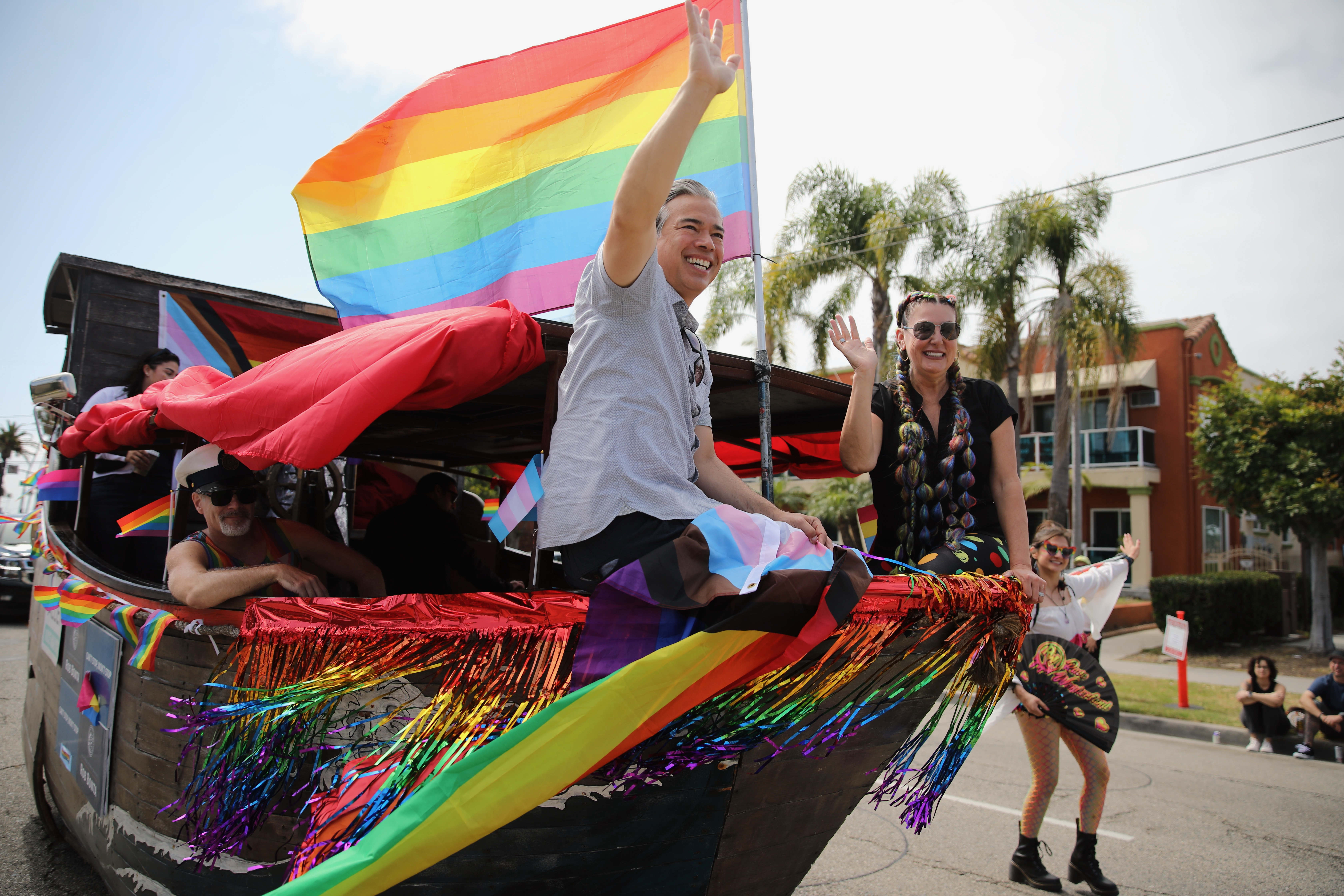 California Attorney General Rob Bonta, left, rides with Long Beach...