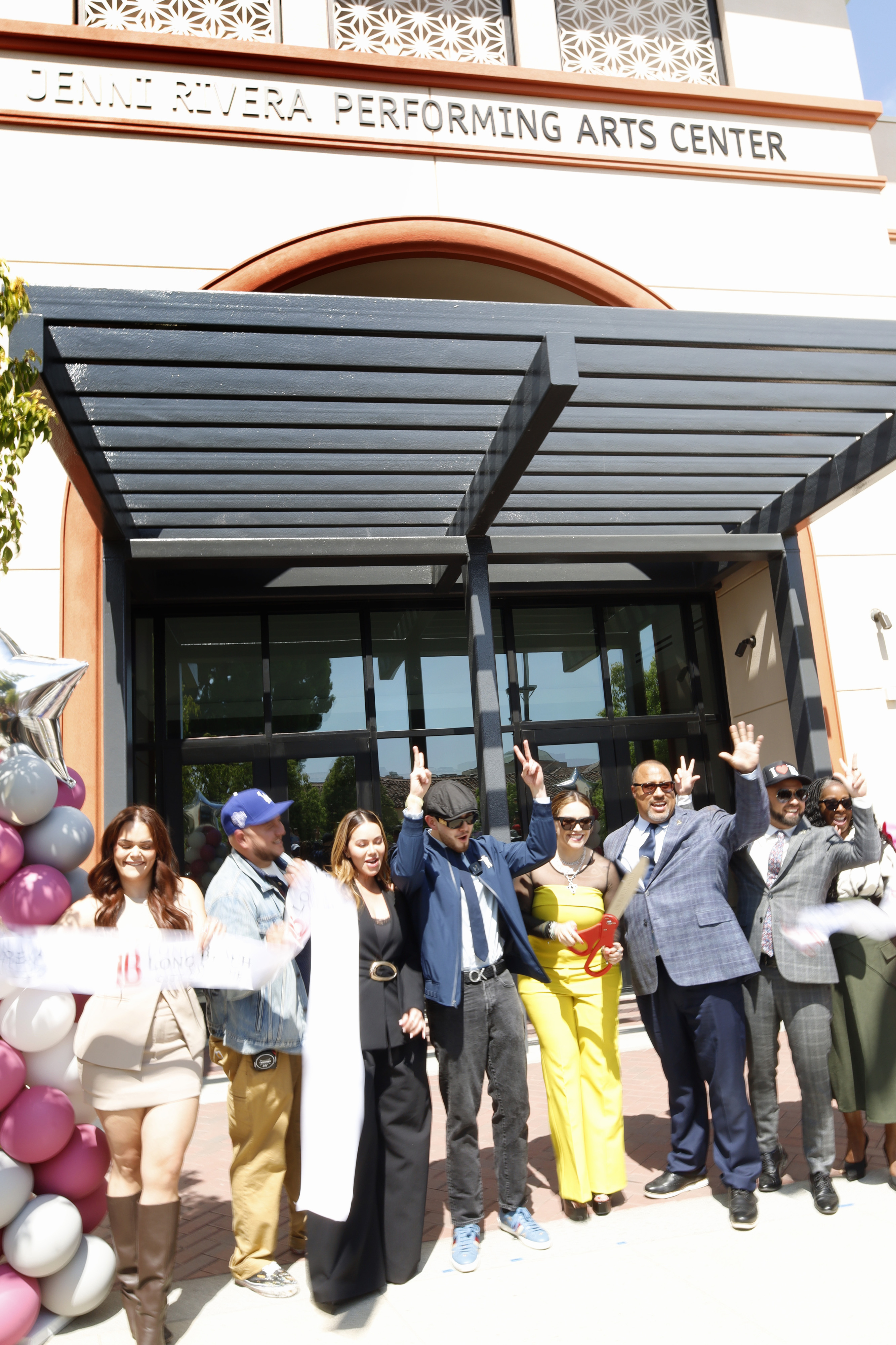 Jacqie Rivera and her siblings cut the ribbon to the...