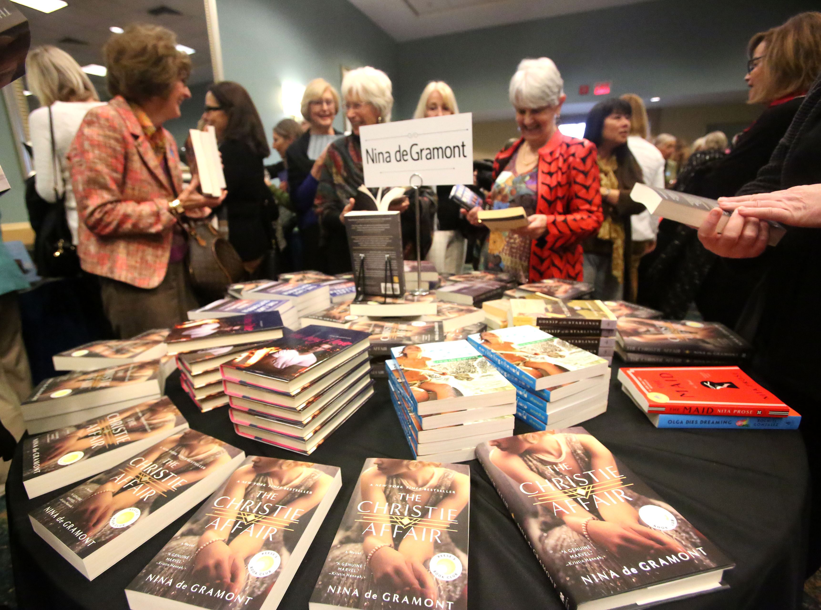 Guest browse through books at the Literary Women Long Beach...