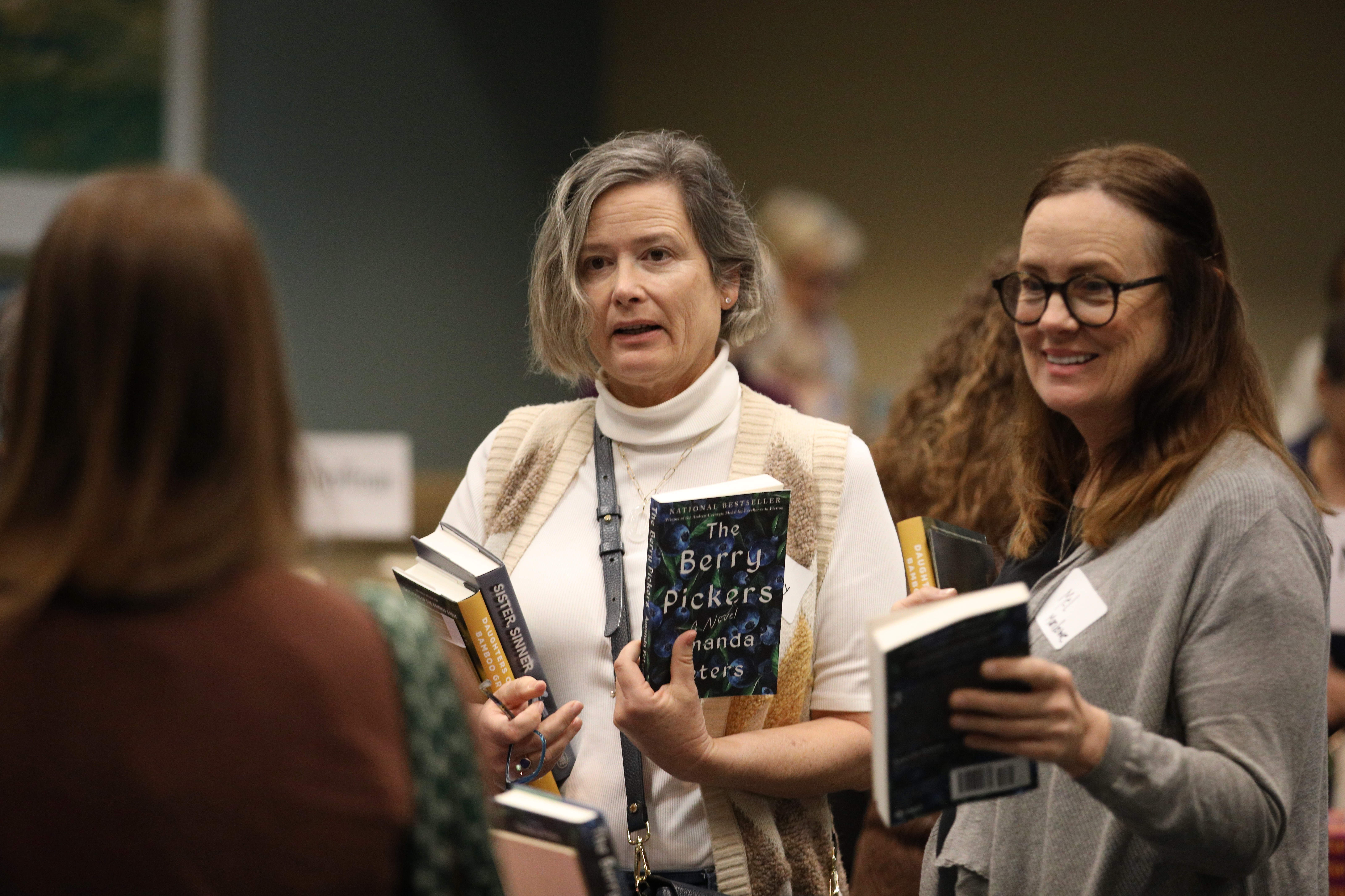Attendees check out some of the books written by the...
