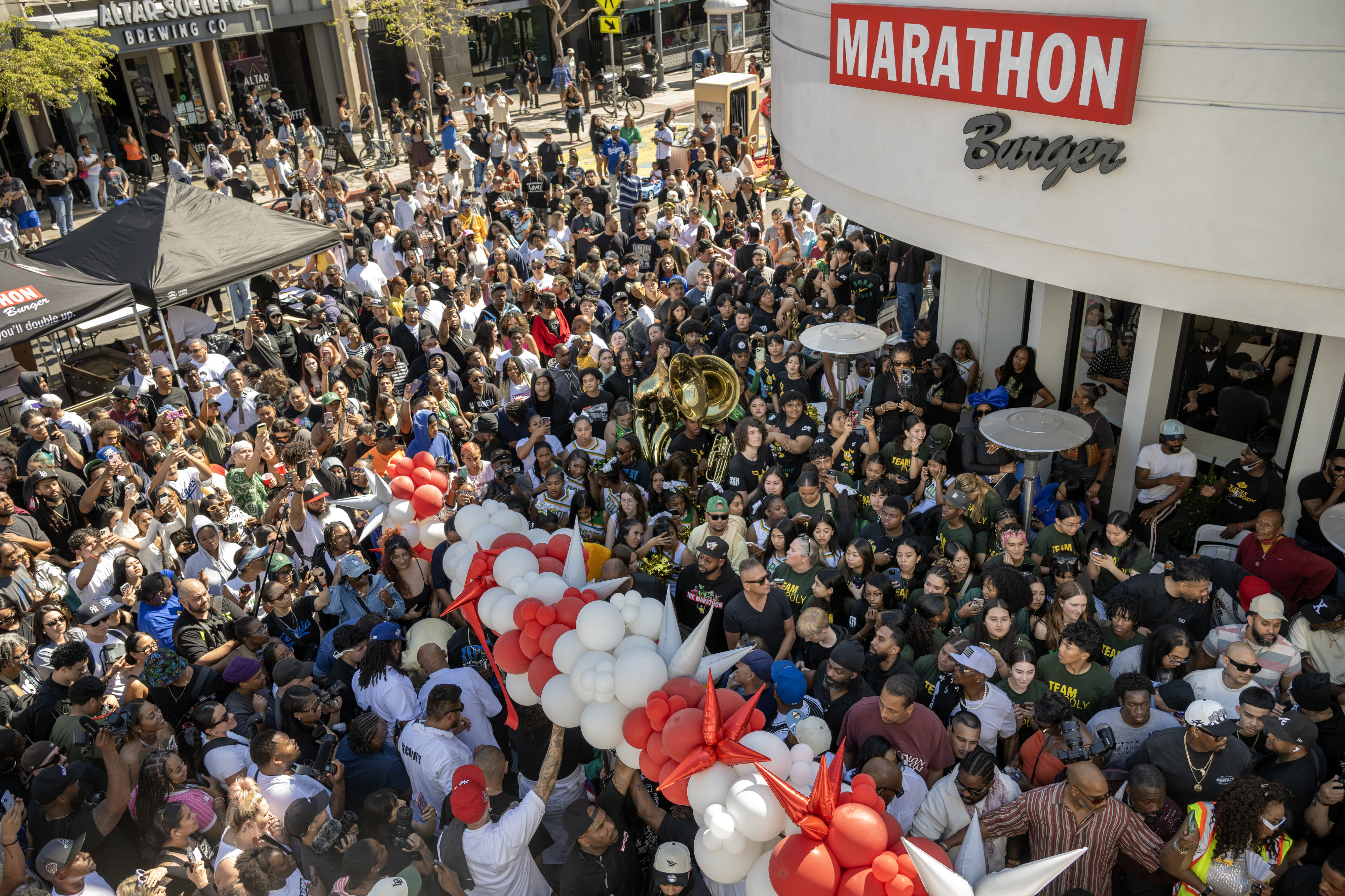 Thousands of people squeeze together outside the new Marathon Burger...