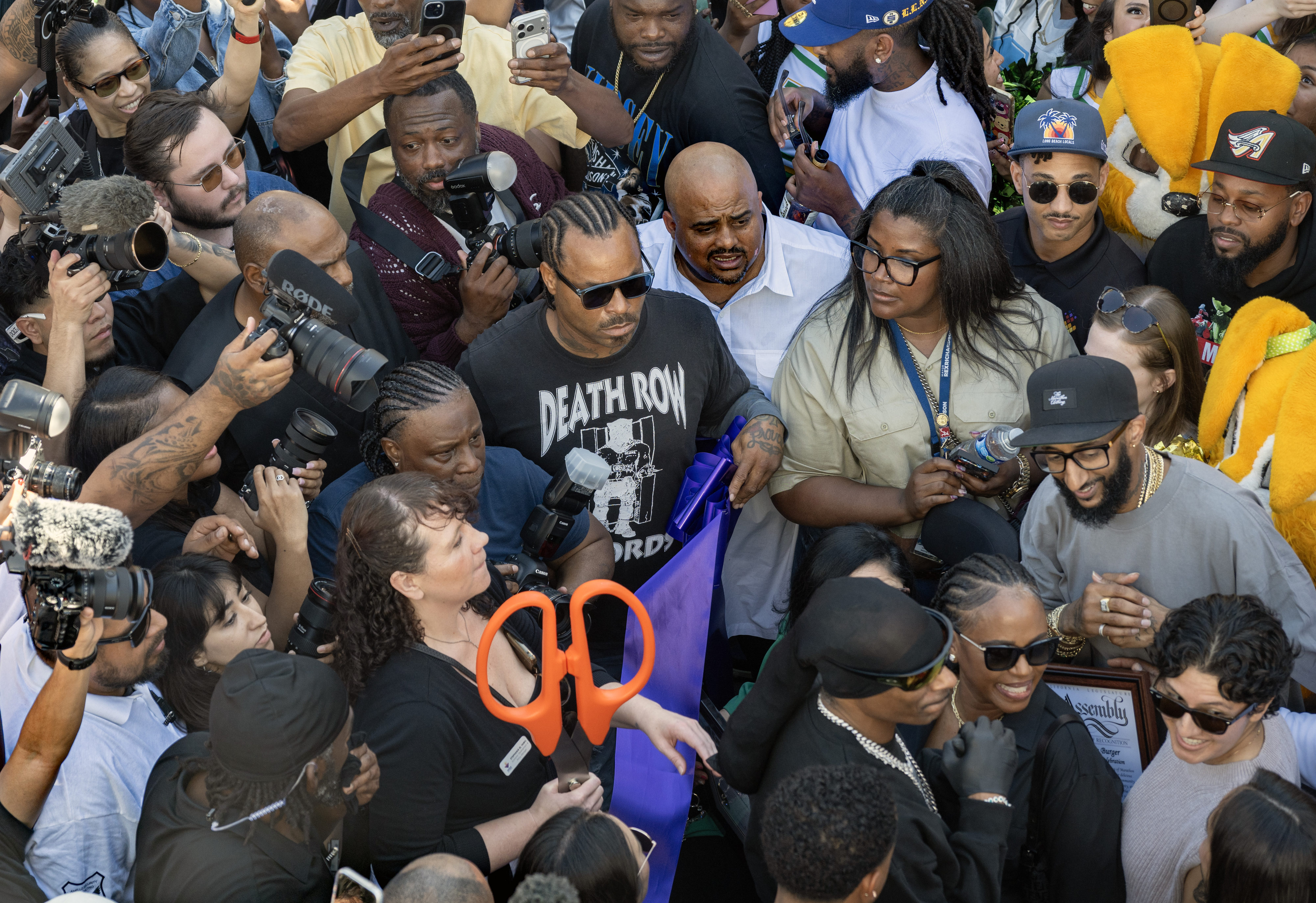 Rapper Snoop Dogg, third from bottom right, and Blacc Sam,...