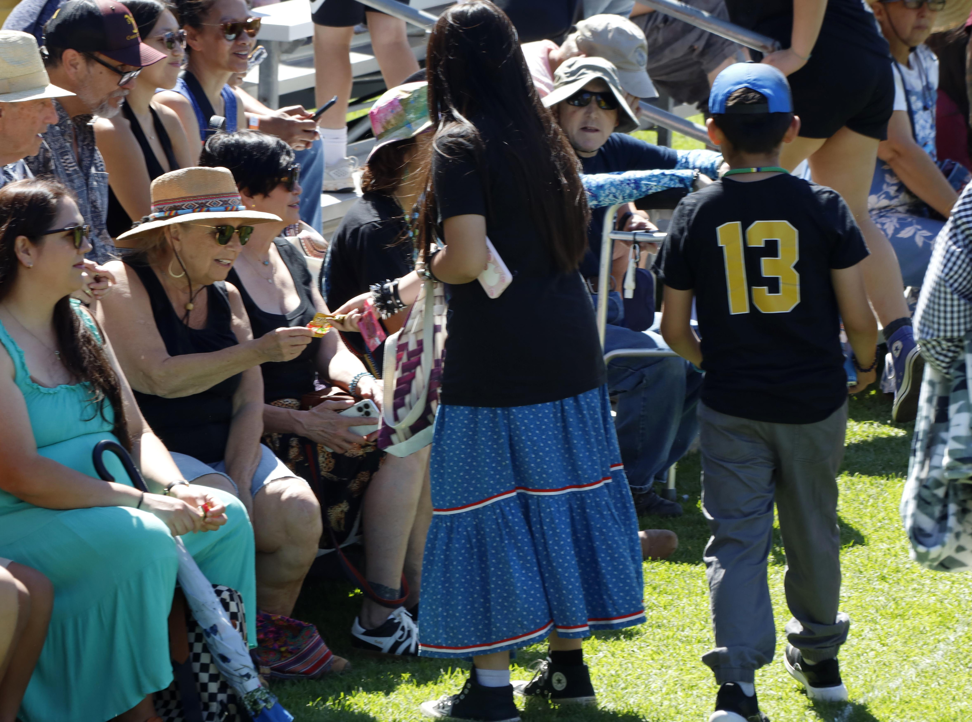 Before the Grand Entry dance, youth from the event hand...