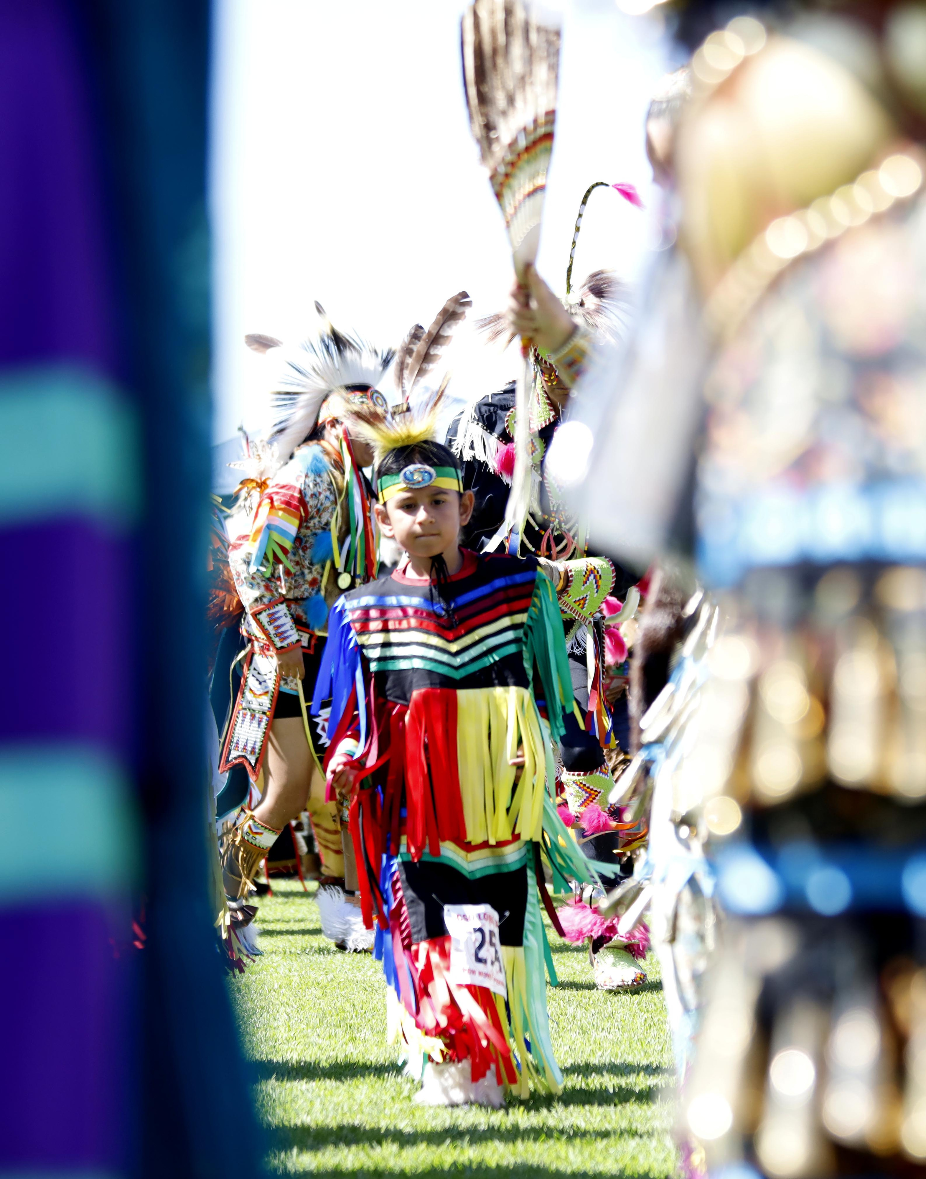 A young dancer performs around the sacred circle during the...