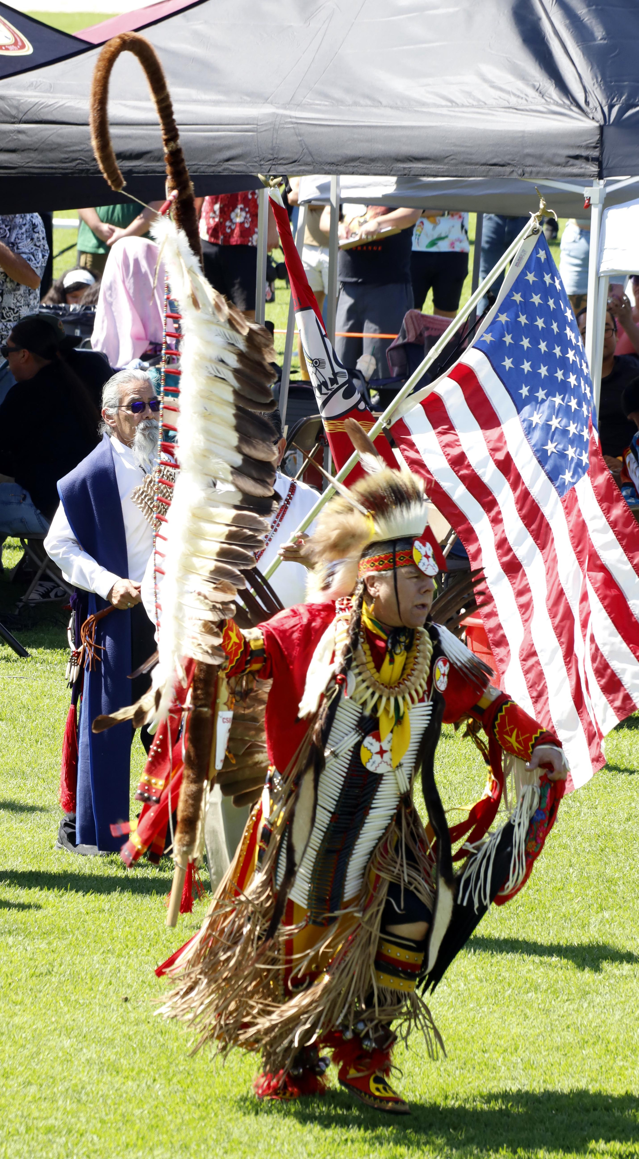 The American flag flies proudly behind the lead dancer that...