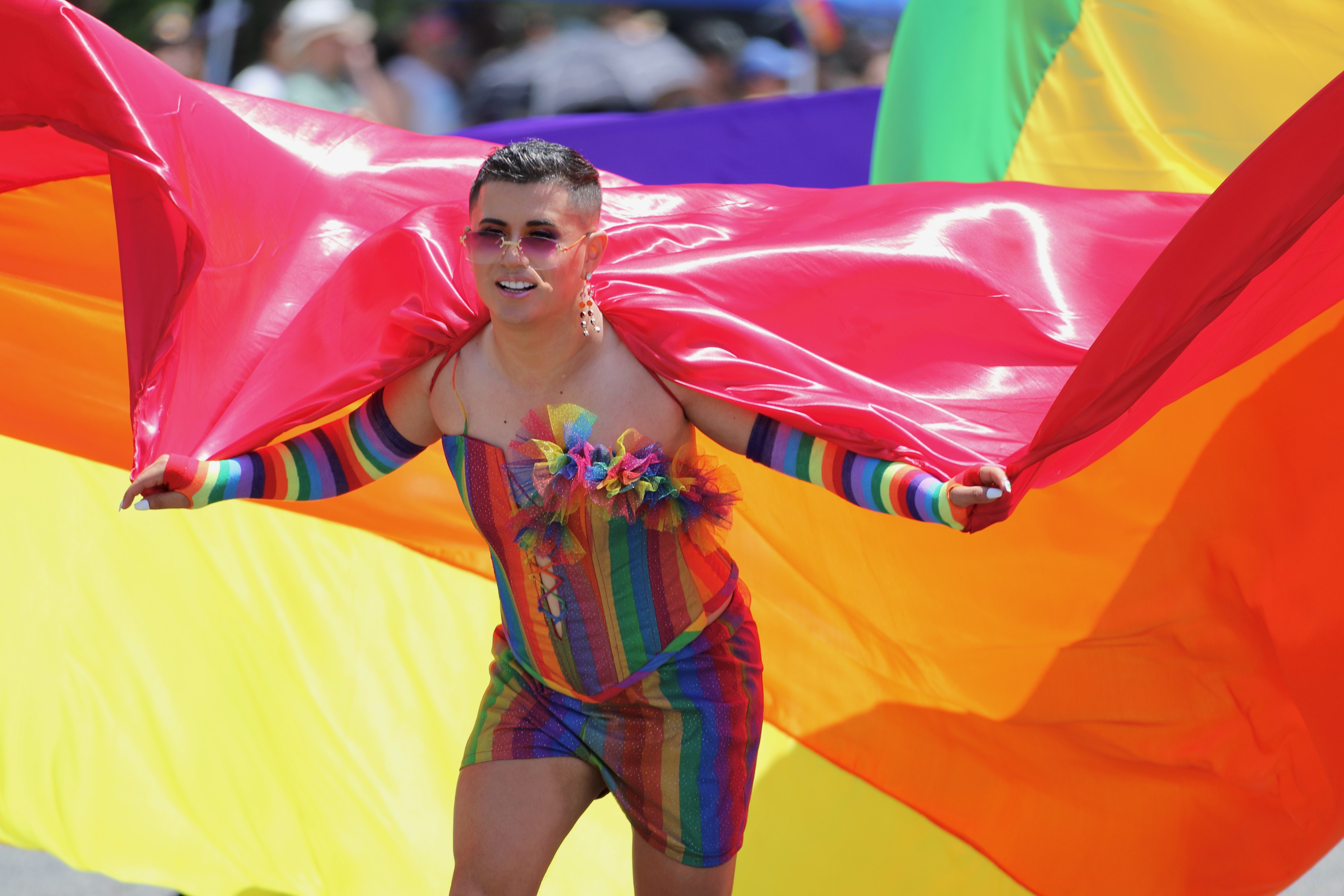 A participant pulls a large flag during the Long Beach...