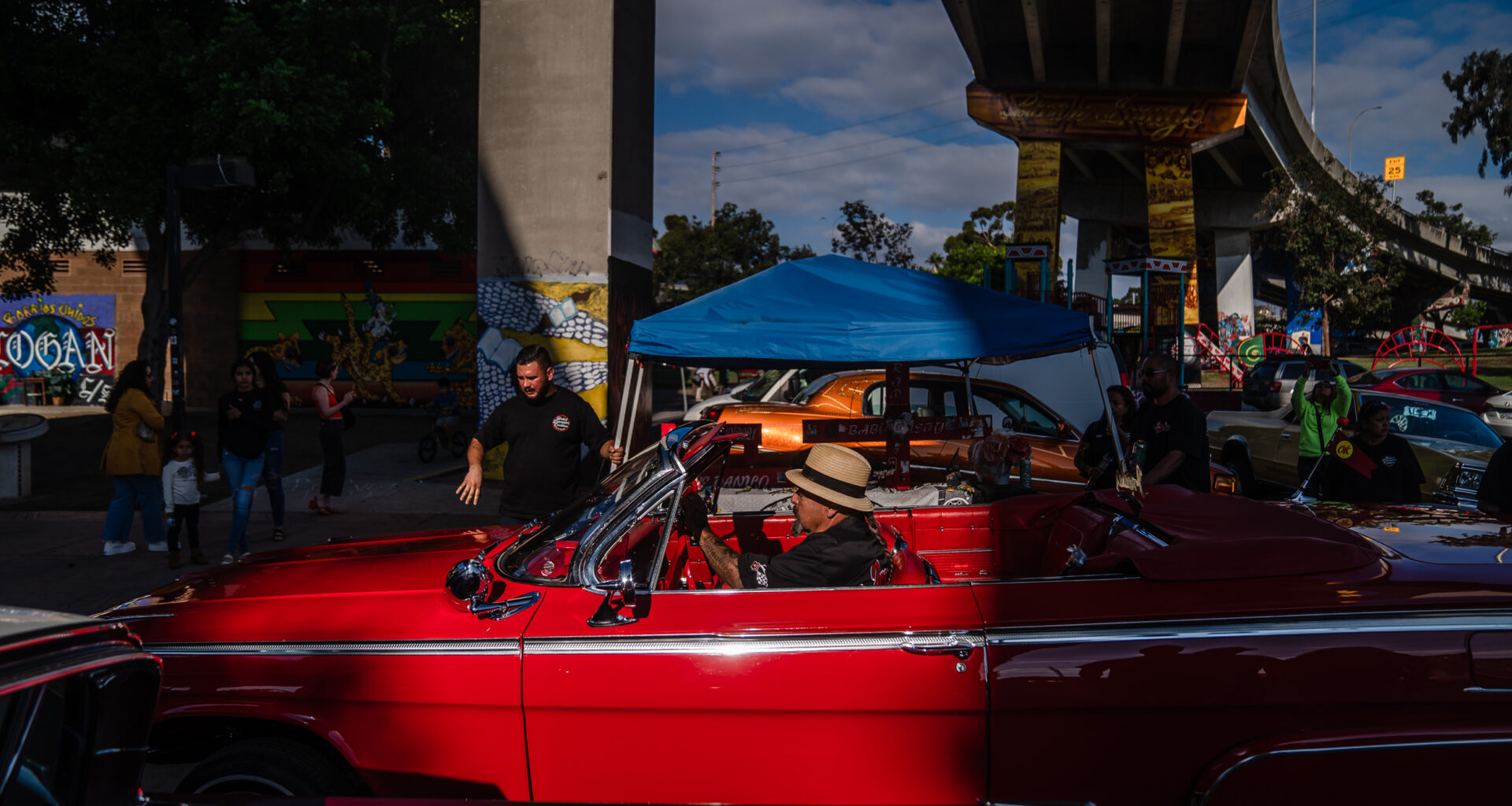 Marcos Arellano in his Impala convertible at Chicano Park in Barrio Logan on Oct. 16, 2022.