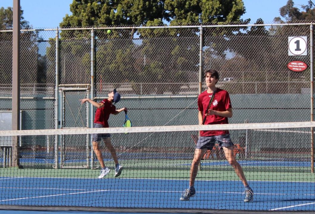 Hunter Lynch, left, delivers a serve during a doubles match while twin brother Thomas awaits the volley return. The brothers would win the set 8-2 on Friday, Feb 20, 2025. Photo by David J. Bohnet/City Times Media