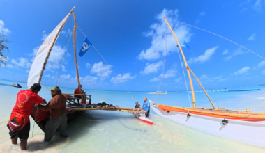 Crew members prep two traditional canoes to go sailing in clear waters in the Mariana Islands