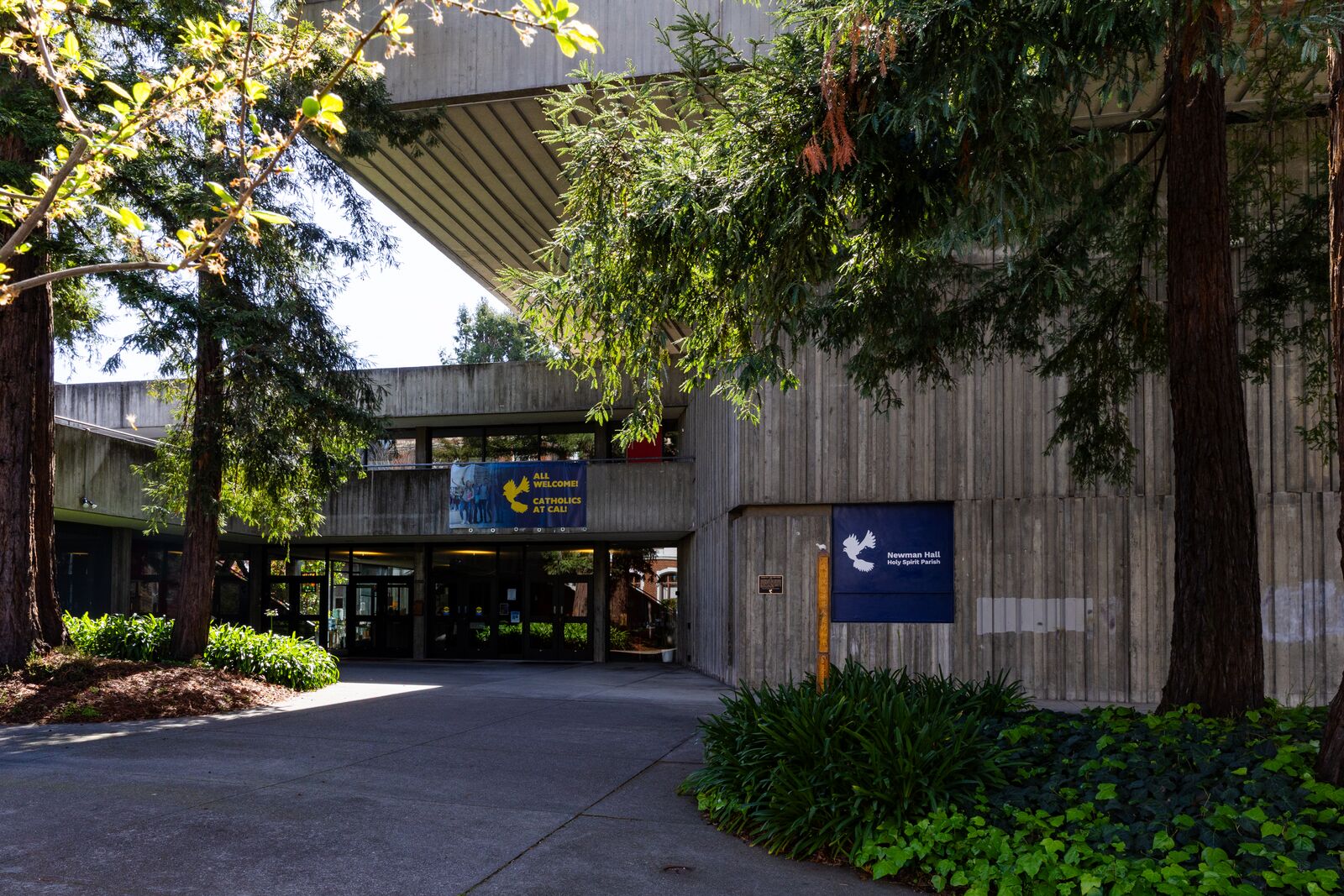 A green courtyard in front of a concrete building