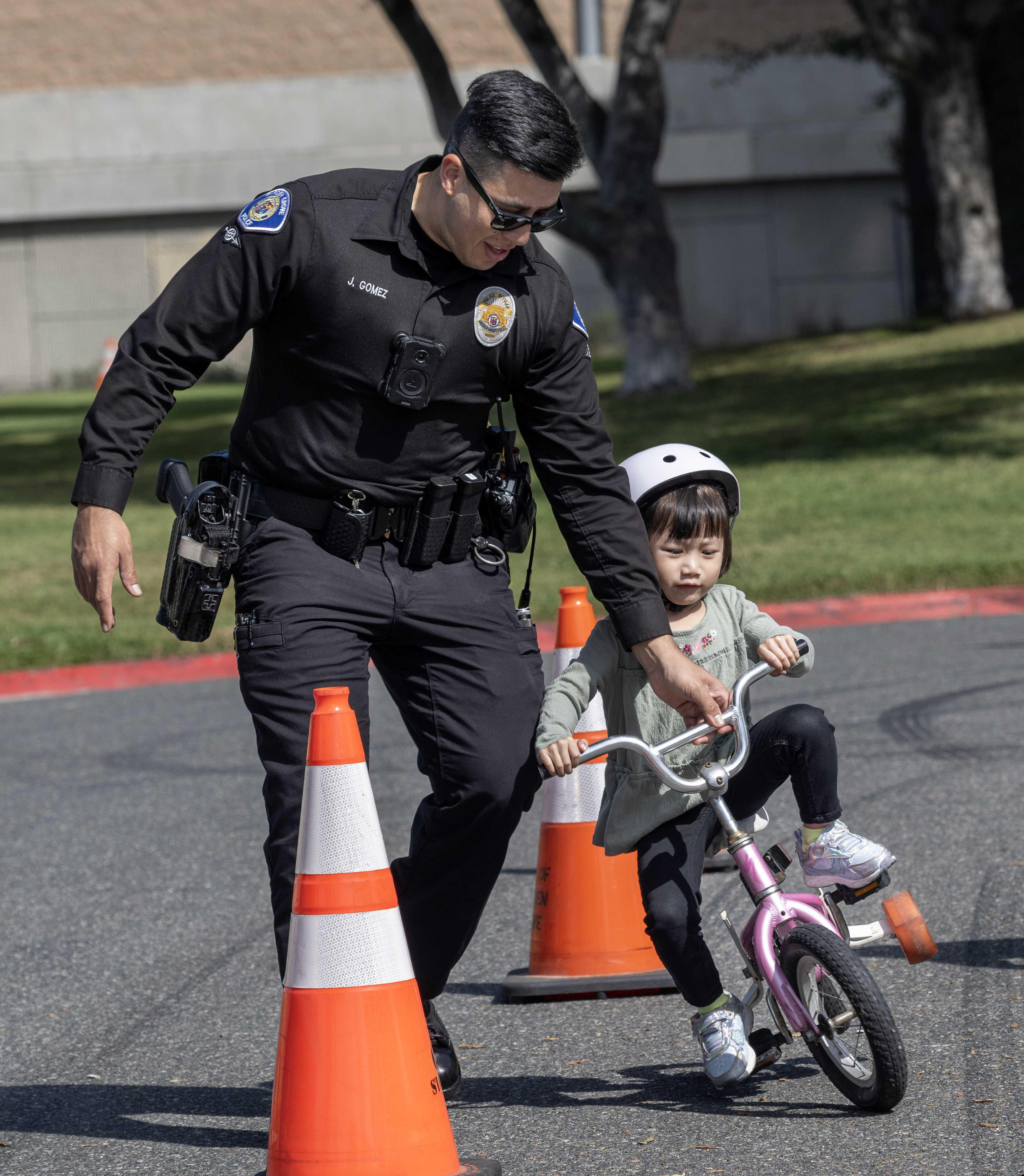 Garden Grove Police officer Jesus Gomez helps 3-year-old Evelyn Vu...