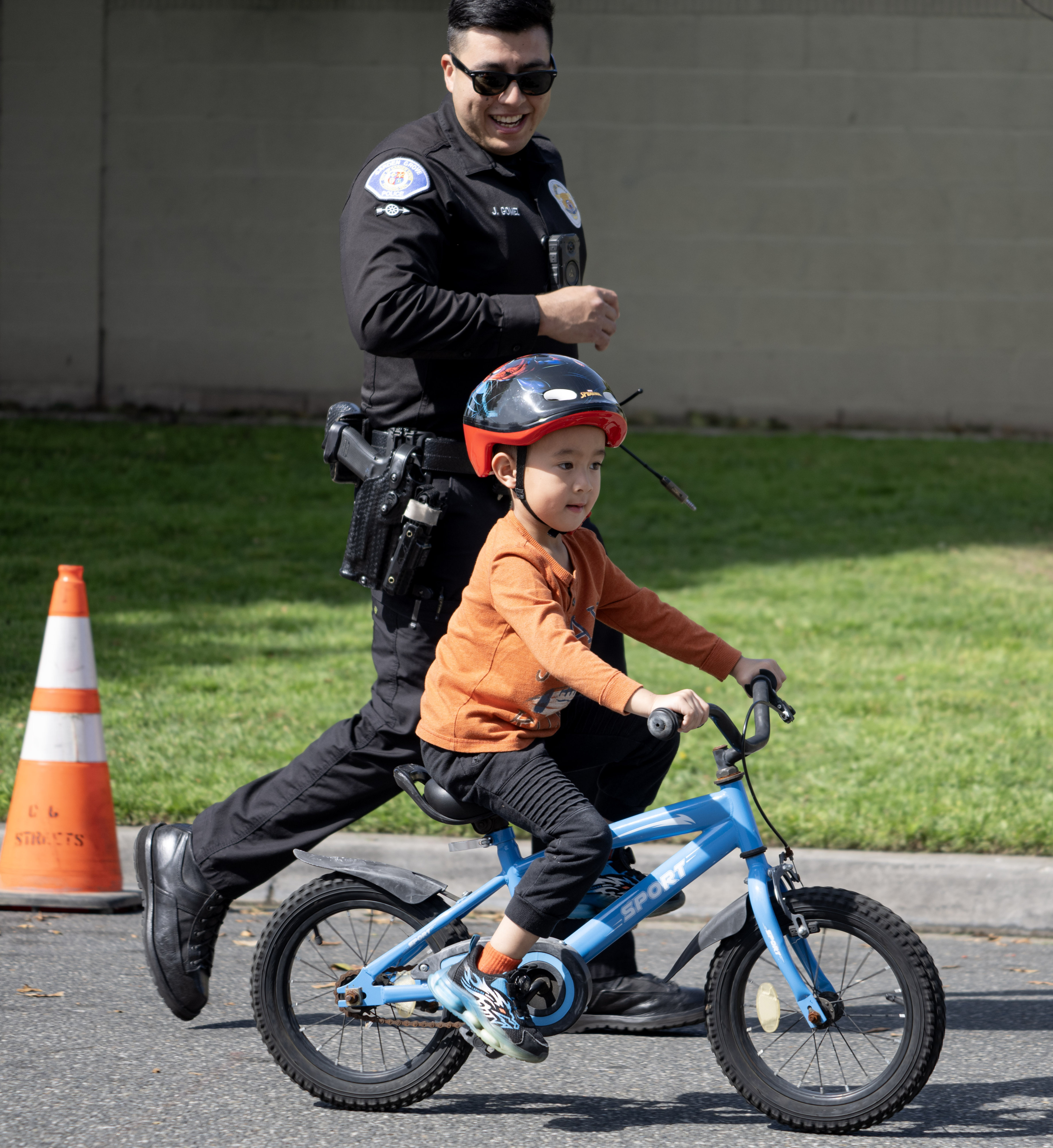 Garden Grove Police officer Jesus Gomez keeps pace with 4-year-old...