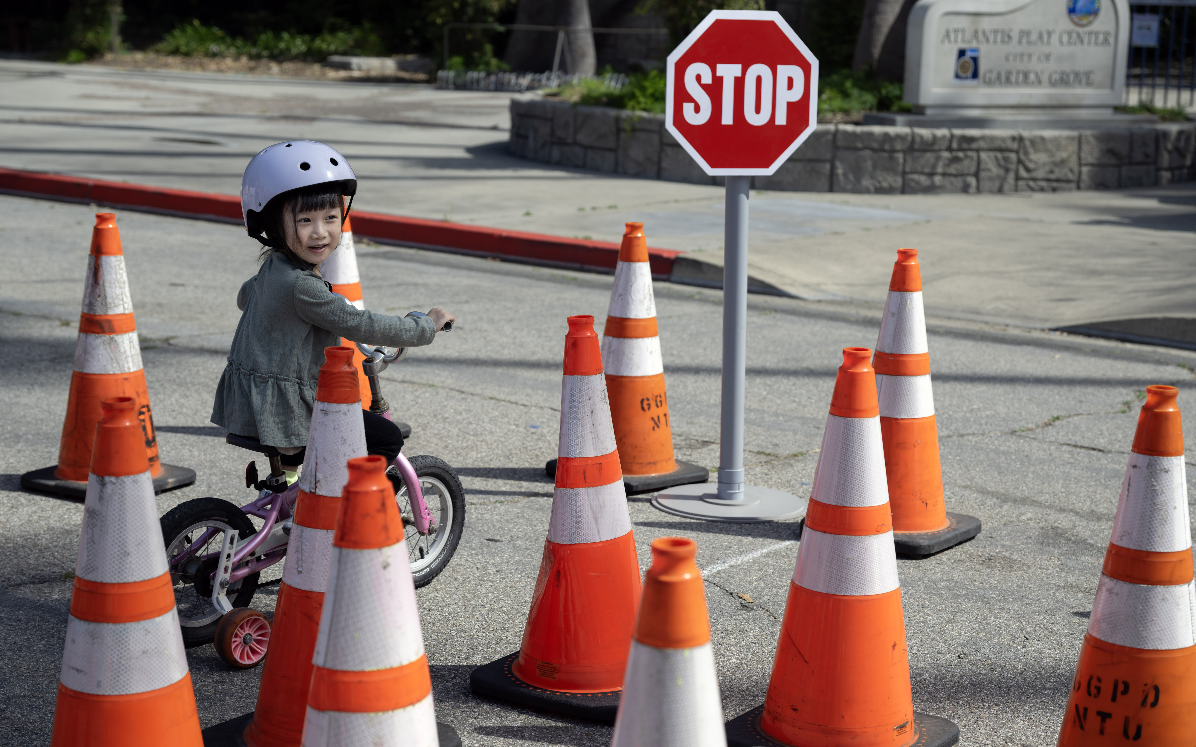 Three-year-old Evelyn Vu makes her way through a maze of...