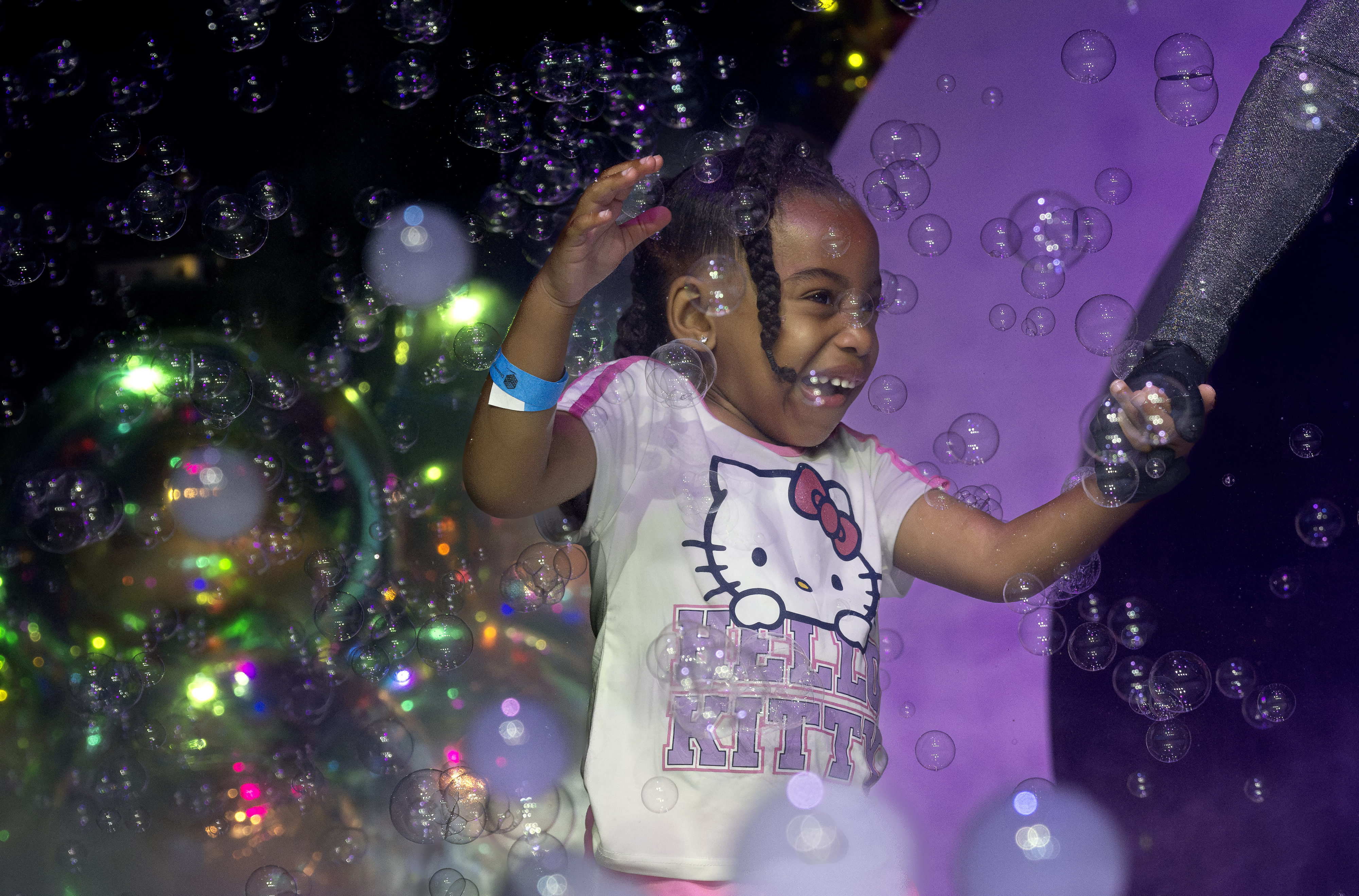 Kenzie Lewis, 4, is led by Melody Yang through a...