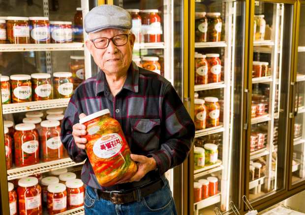 Deok Eui Kim, owner of Hansung Ggoolmott Kimchi, with a gallon-sized jar of his Kimchi in Buena Park on Monday, March 9, 2026. In 1987, Kim started making kimchi in his garage and opened the storefront location in 1997. (Photo by Leonard Ortiz, Orange County Register/SCNG)