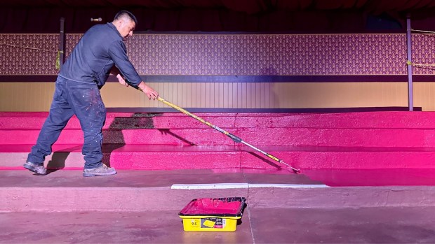 A worker slurries the terraced seating area of the Bird Cage Theatre at Knott's Berry Farm. (Photo by Brady MacDonald, Orange County Register/SCNG)