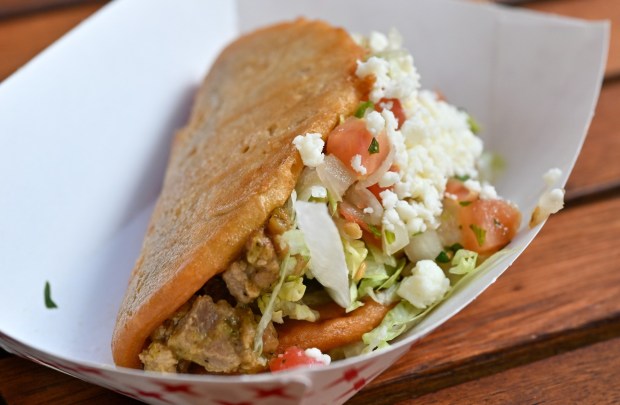 Pork Chile Verde Chalupas; a chalupas filled with pork in salsa verde, shredded lettuce, pico de gallo and queso fresco served with Spanish rice and refried beans topped with queso fresco at Paradise Garden Grill in Paradise Garden during the California Food & Wine Festival inside California Adventure running March 6 through April 27, 2026. Photographed on Friday, March 6, 2026. (Photo by Jeff Gritchen, Orange County Register/SCNG)