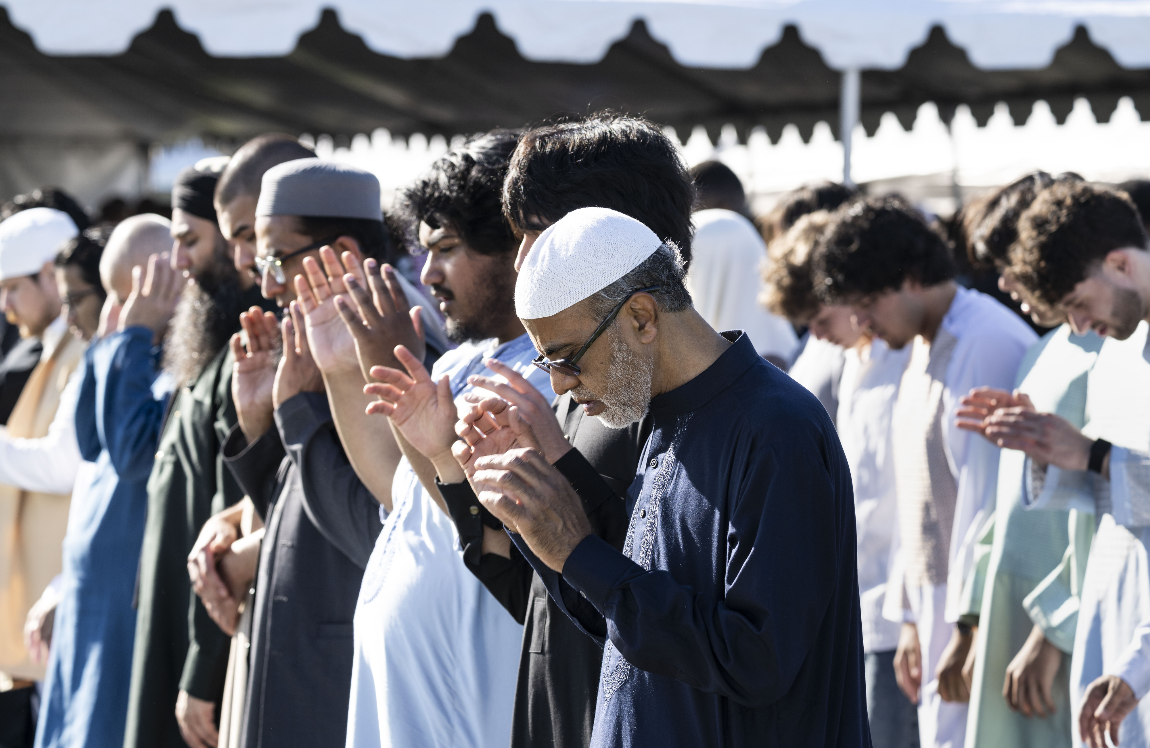 Men pray during an Eid ul-Fitr celebration in Garden Grove,...