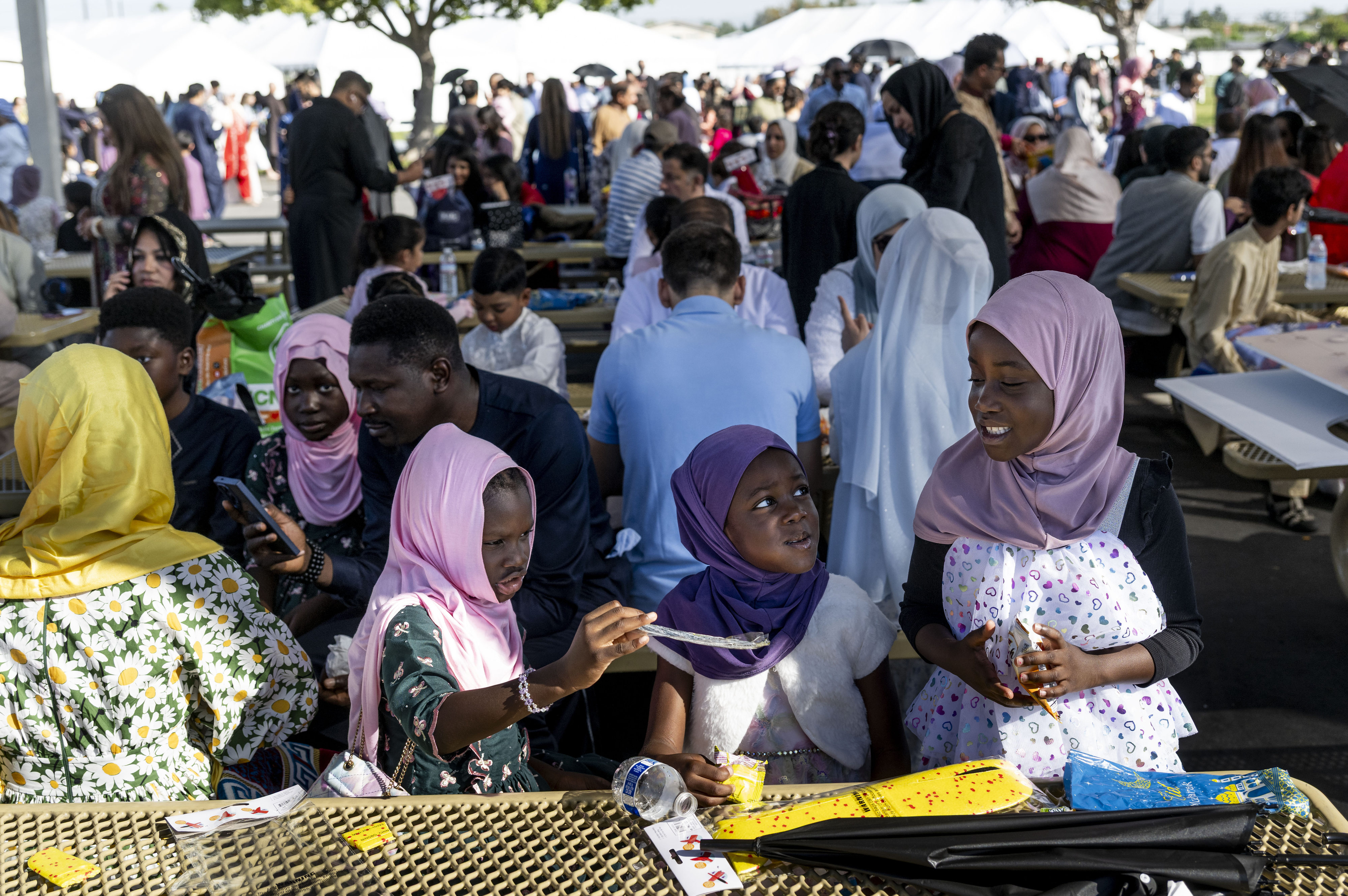 People have food following an Eid ul-Fitr celebration in Garden...