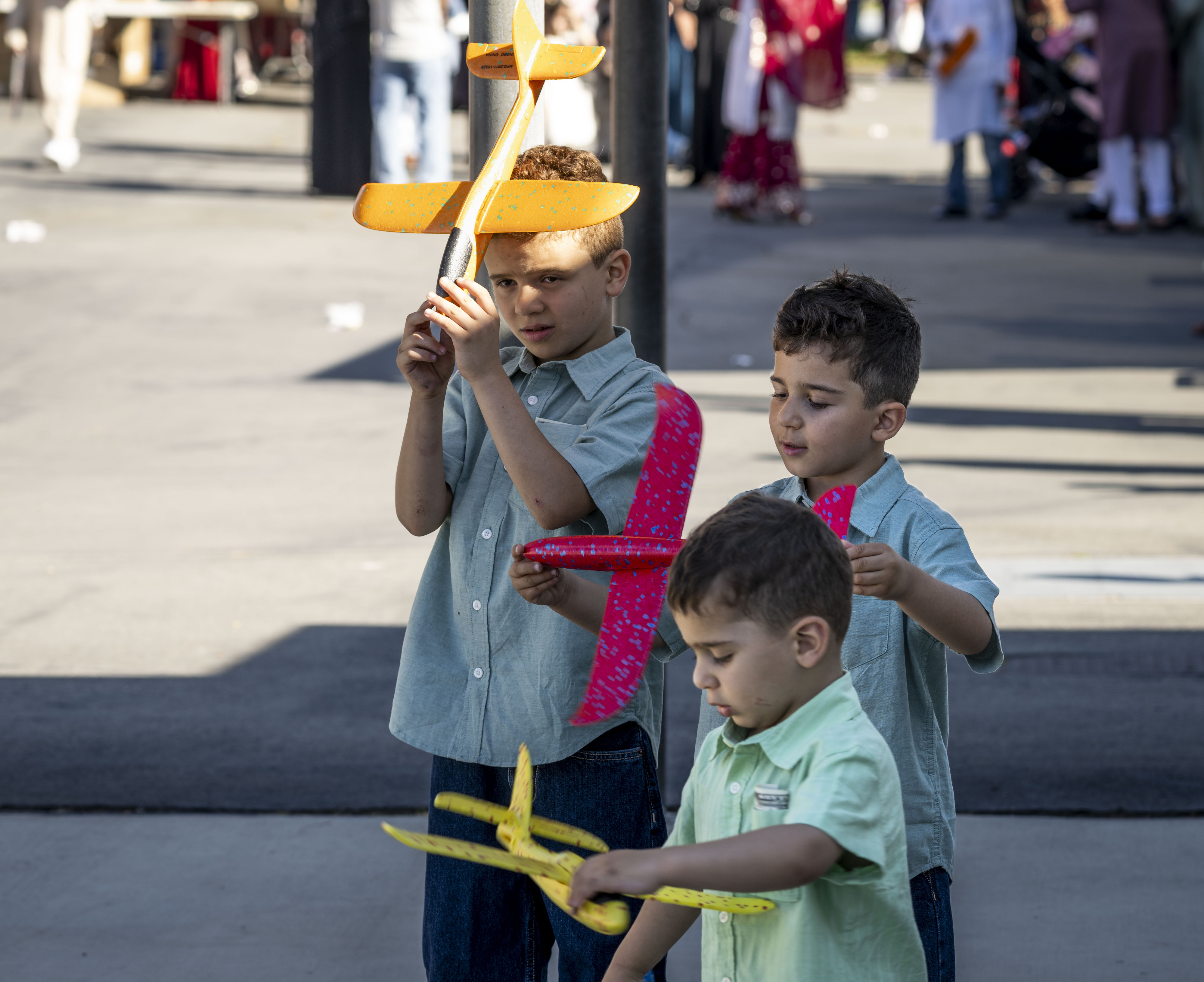 Omar, Zyde and Kenan Masri pla with toy planes following...