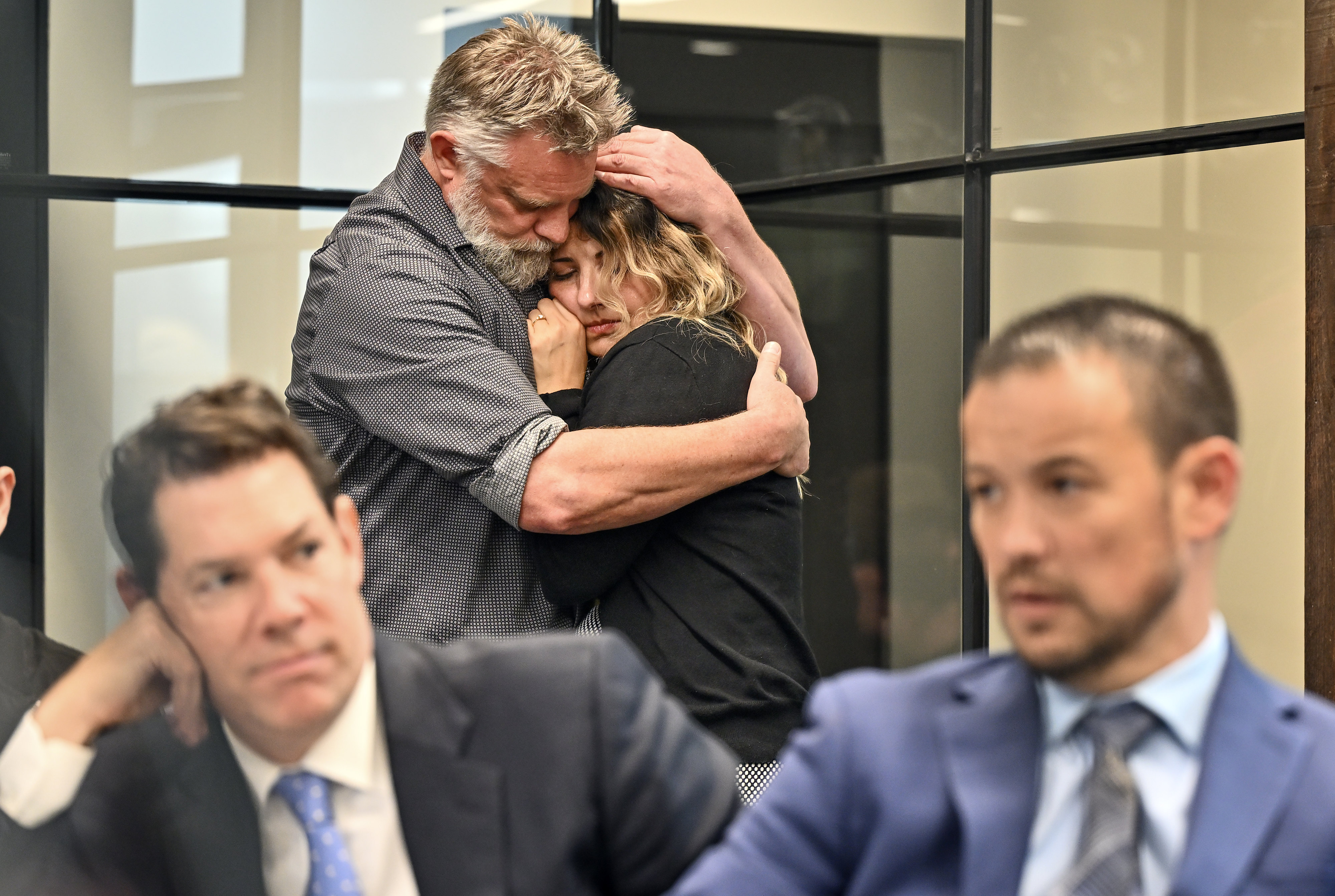 Berenice Cervantes and Curtis Hanson comfort each other during a...