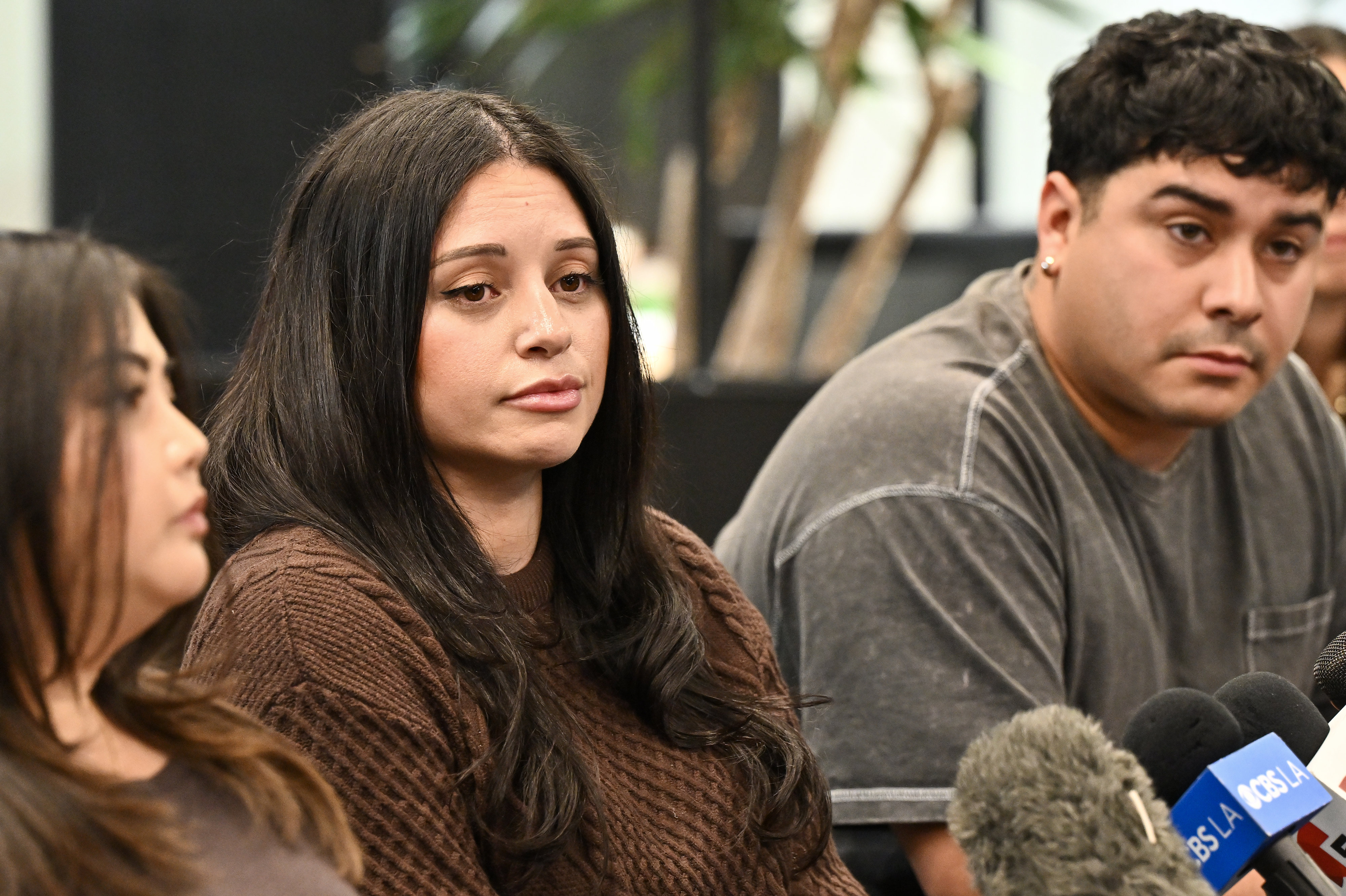 Marina Reyes, center, and Jorge Reyes, right, during a press...