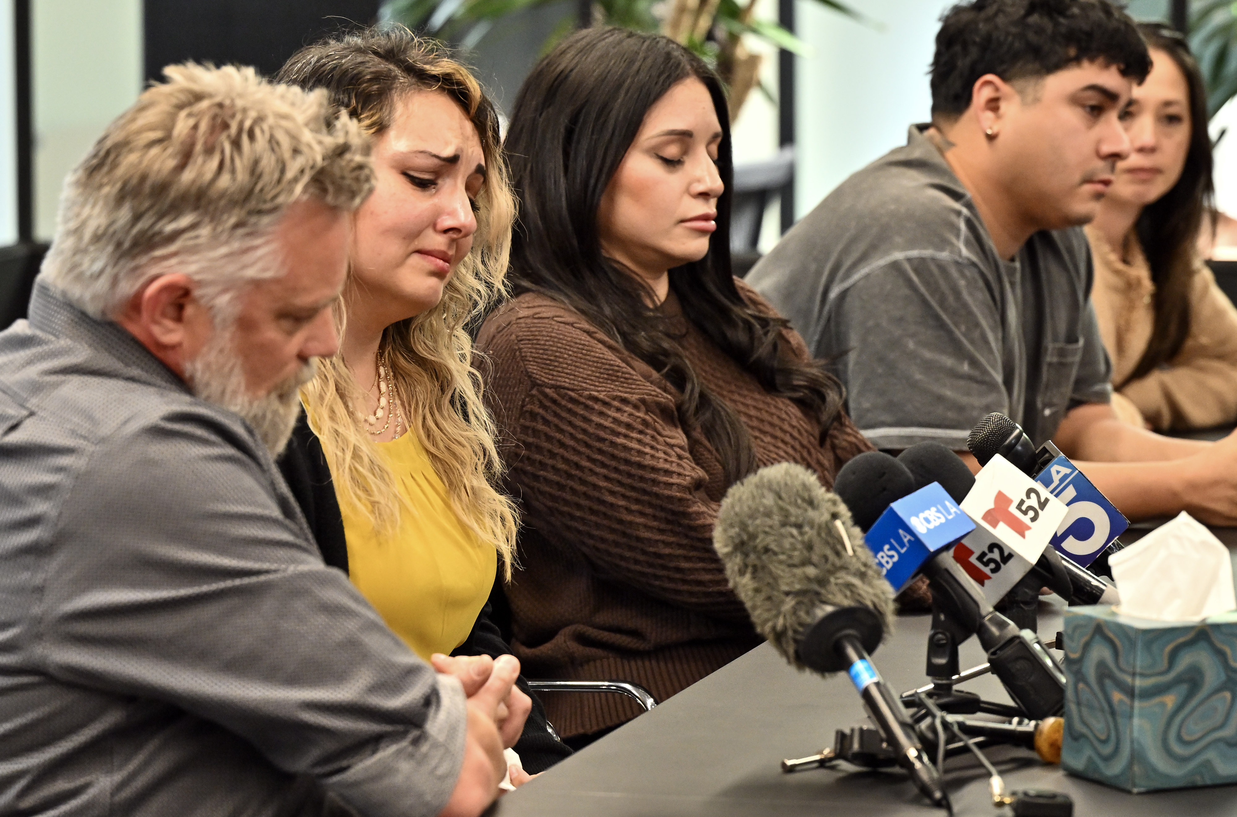 Berenice Cervantes tears up as she sits with Curtis Hanson,...