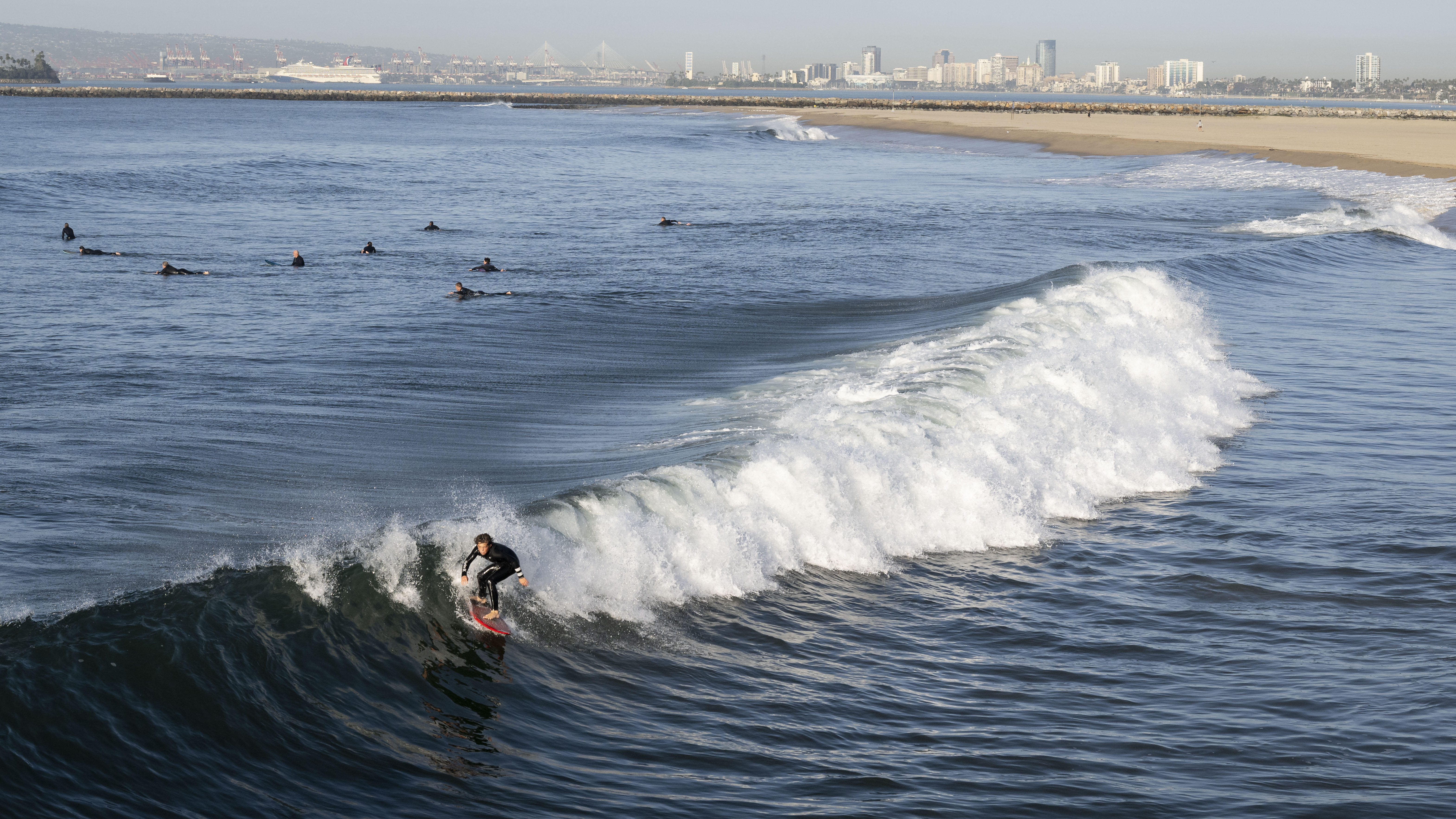 SEAL BEACH, CA – February 02: A surfer rides a...