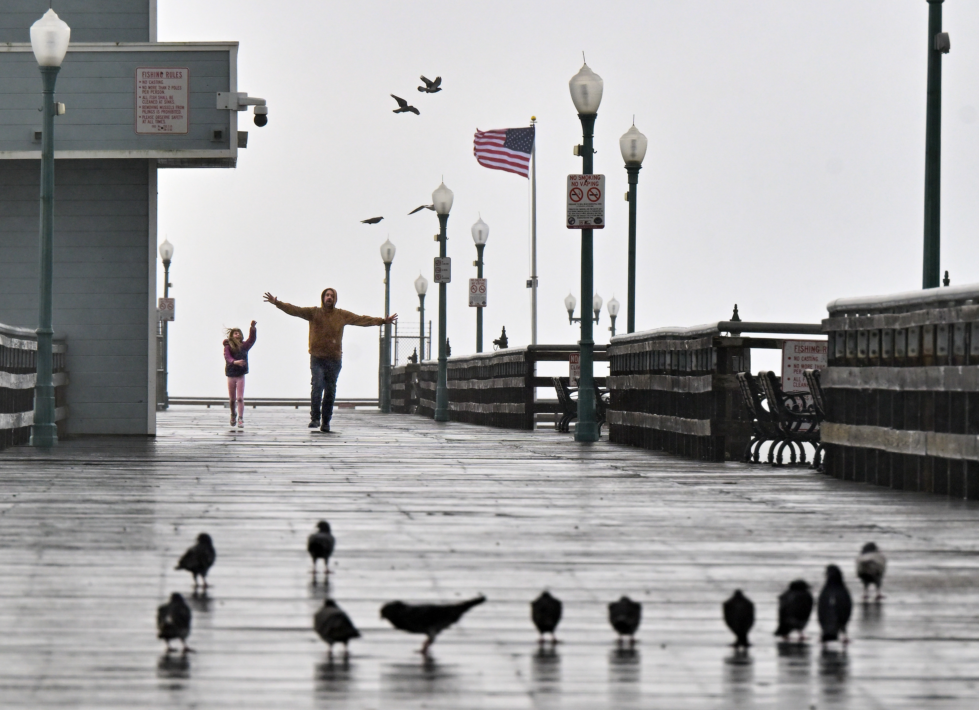 Bryce Land and his daughter, Eliza Land, frolic in the...