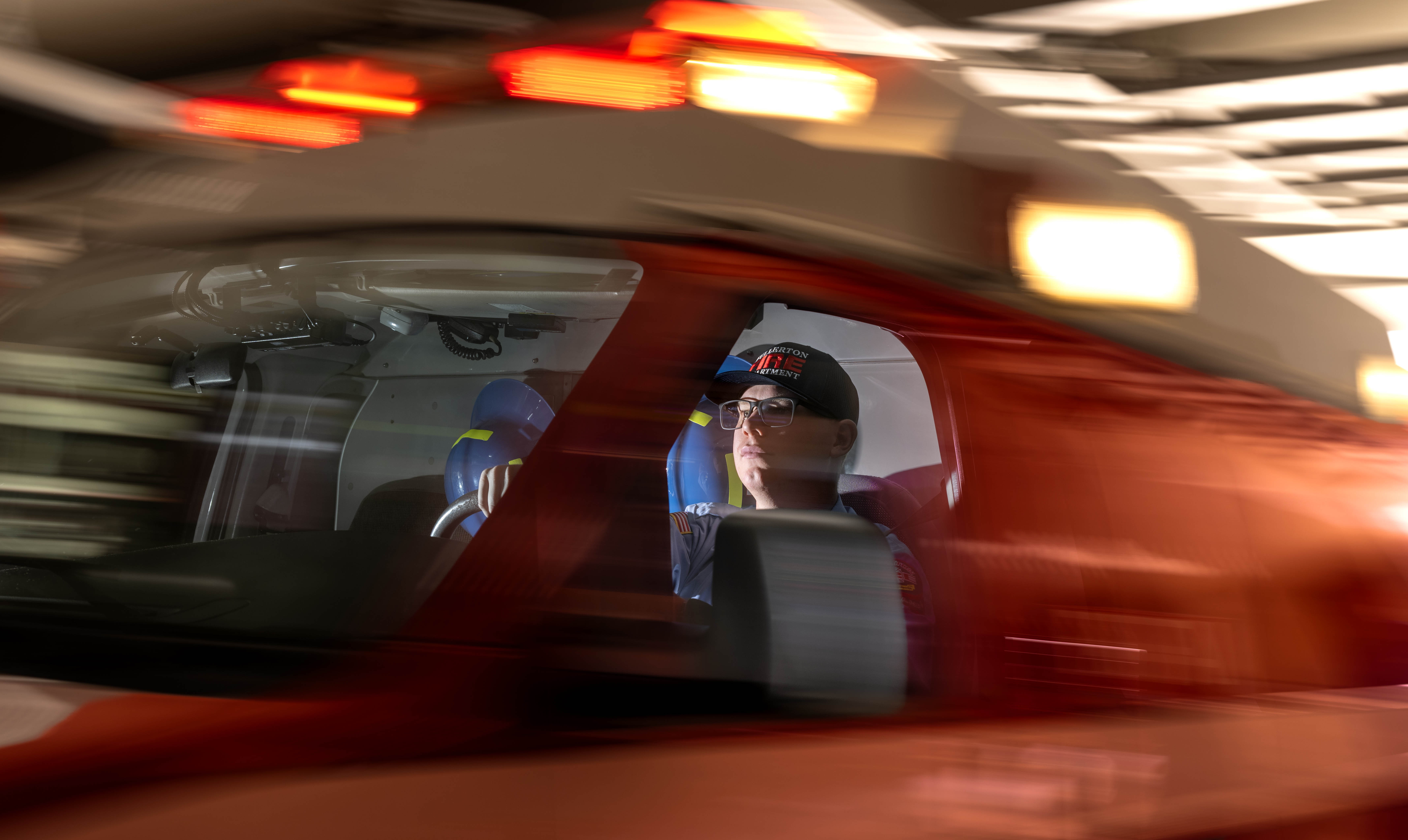 Fullerton Fire Department ambulance operator Patrick Manfredi sits inside an...
