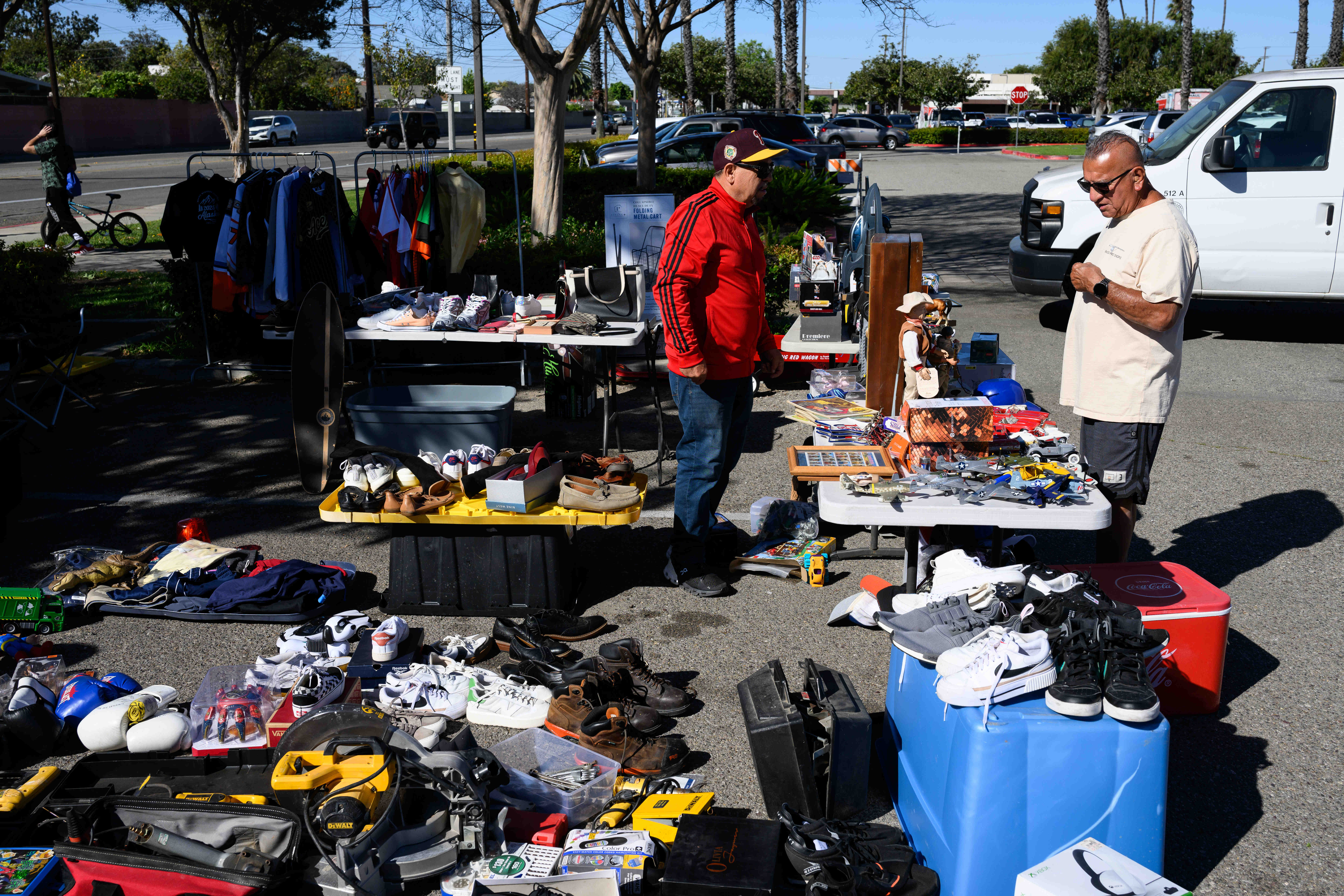 Arturo Loza, left, helps out a customer at his stall...