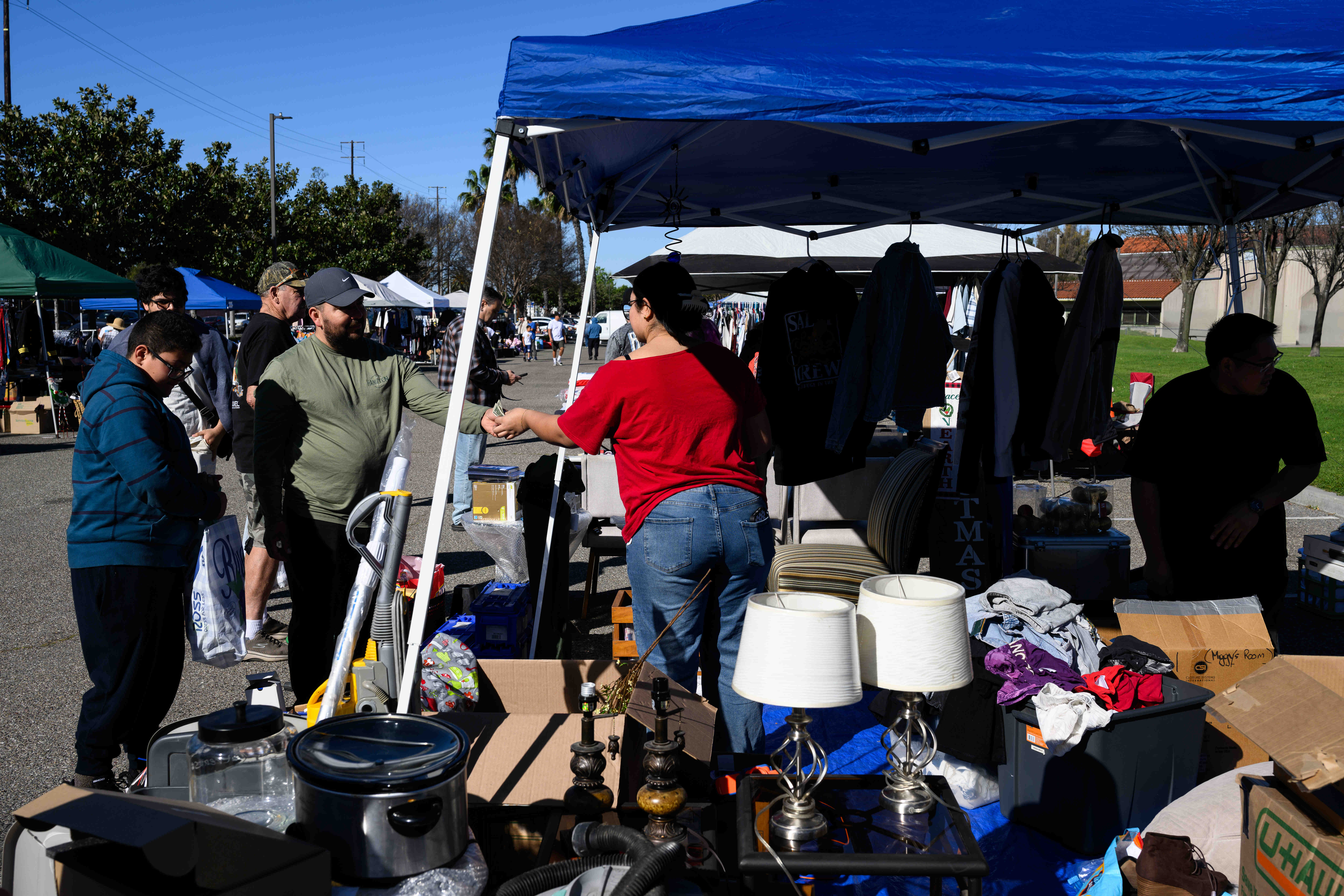 A vendor makes a sale during a community yard sale...