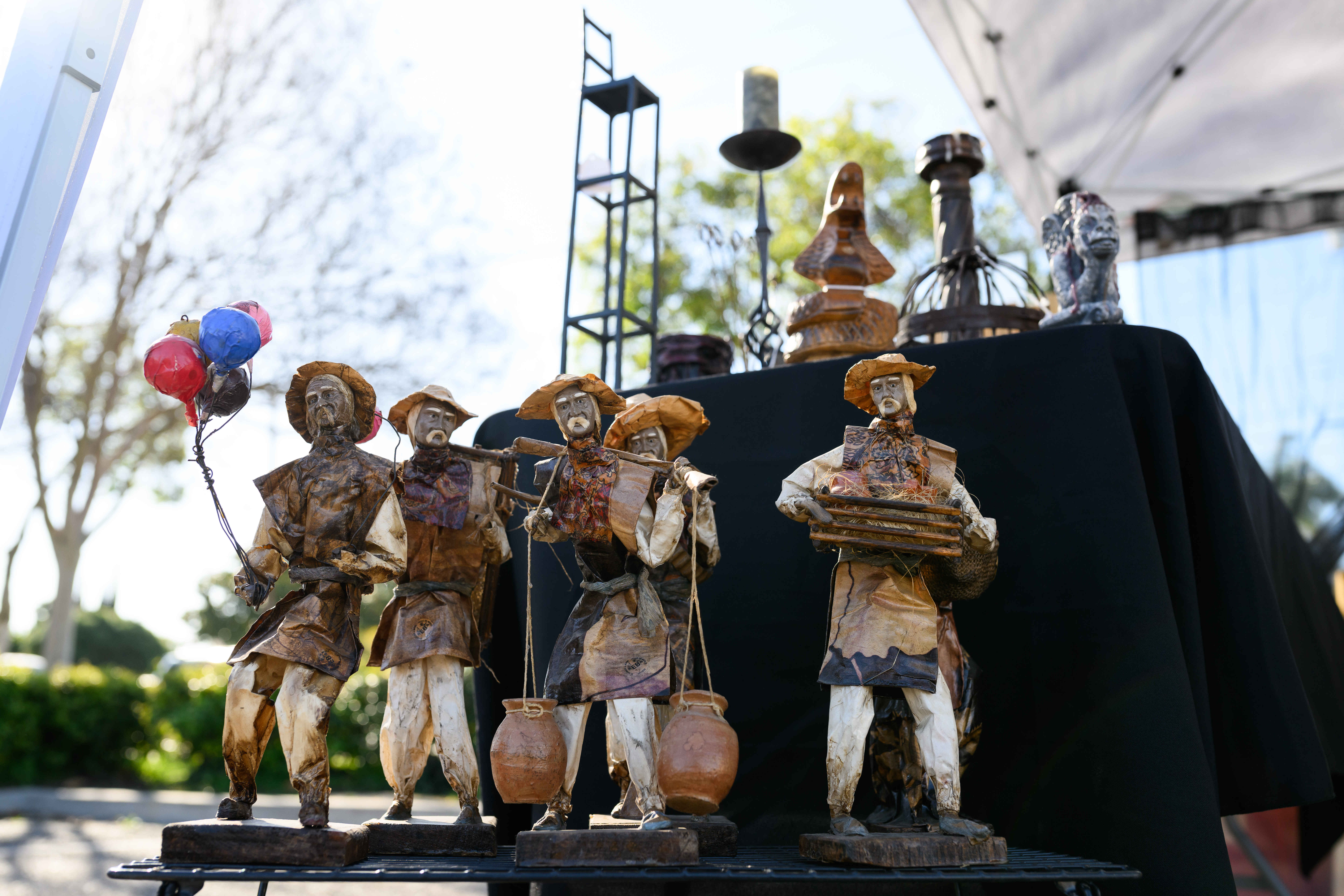 Mini statues are seen on display during a community yard...