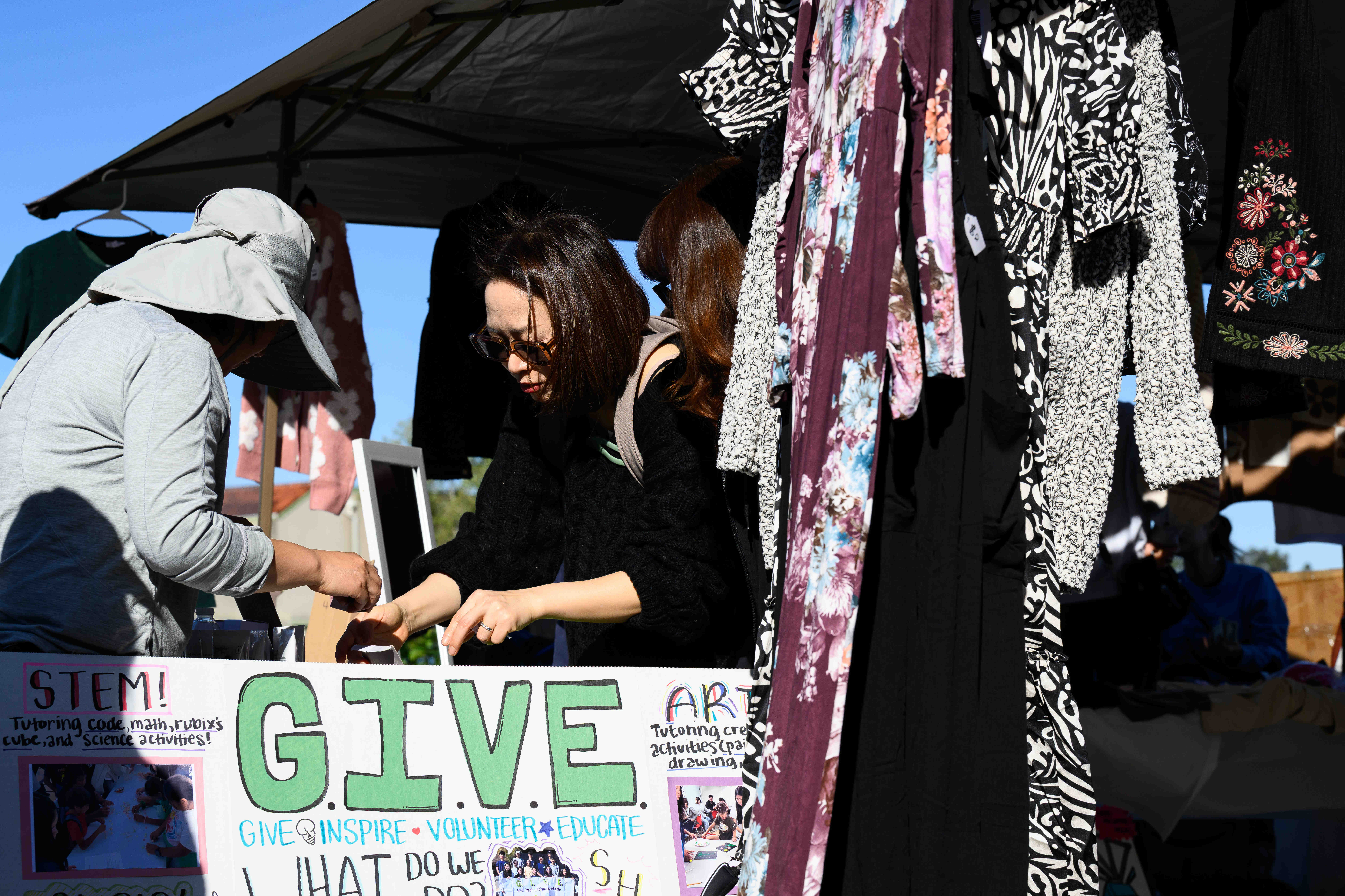 Hannah Huh, center, from the CAL GIVE Foundation, helps a...