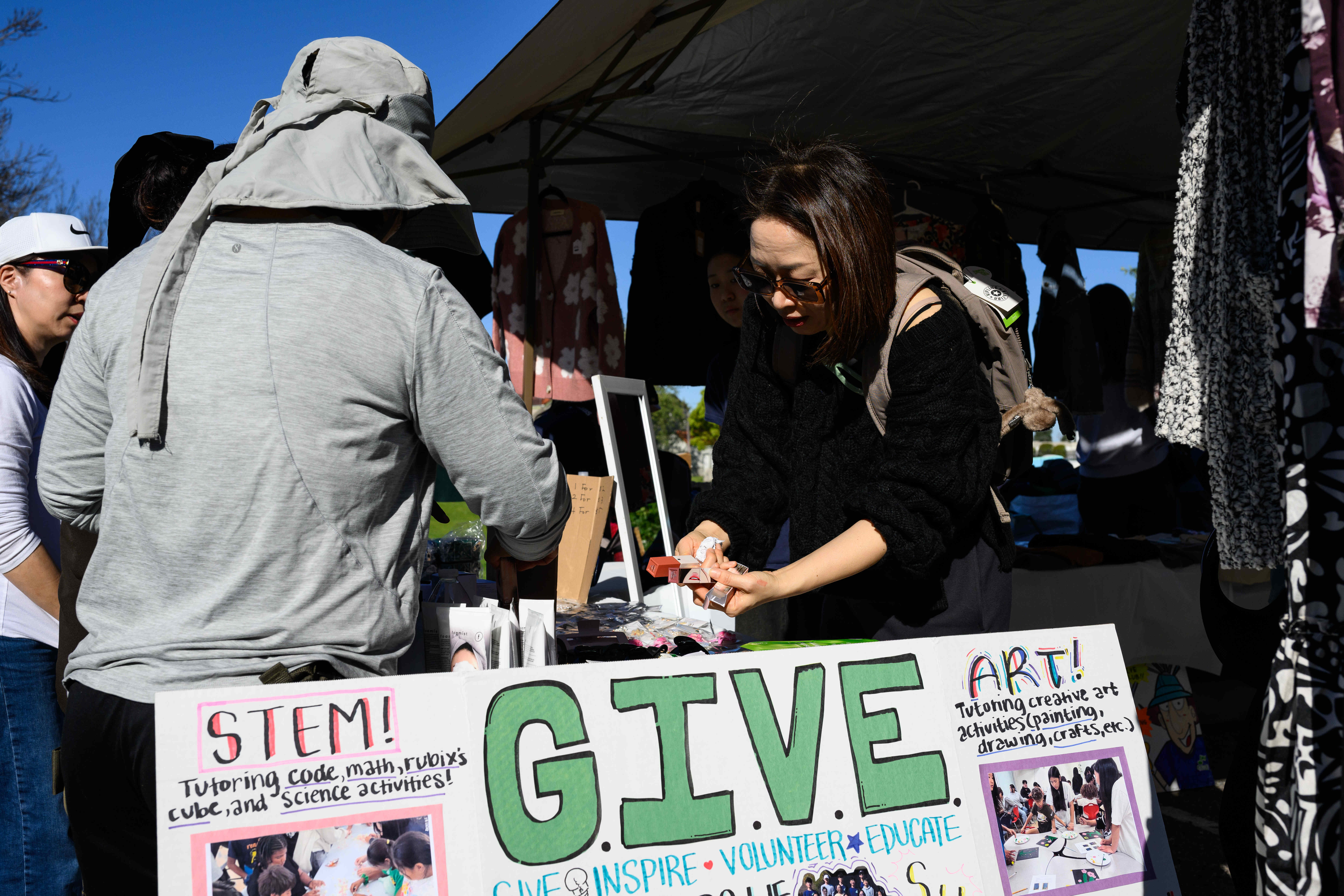 Hannah Huh, right, from the CAL GIVE Foundation, helps a...