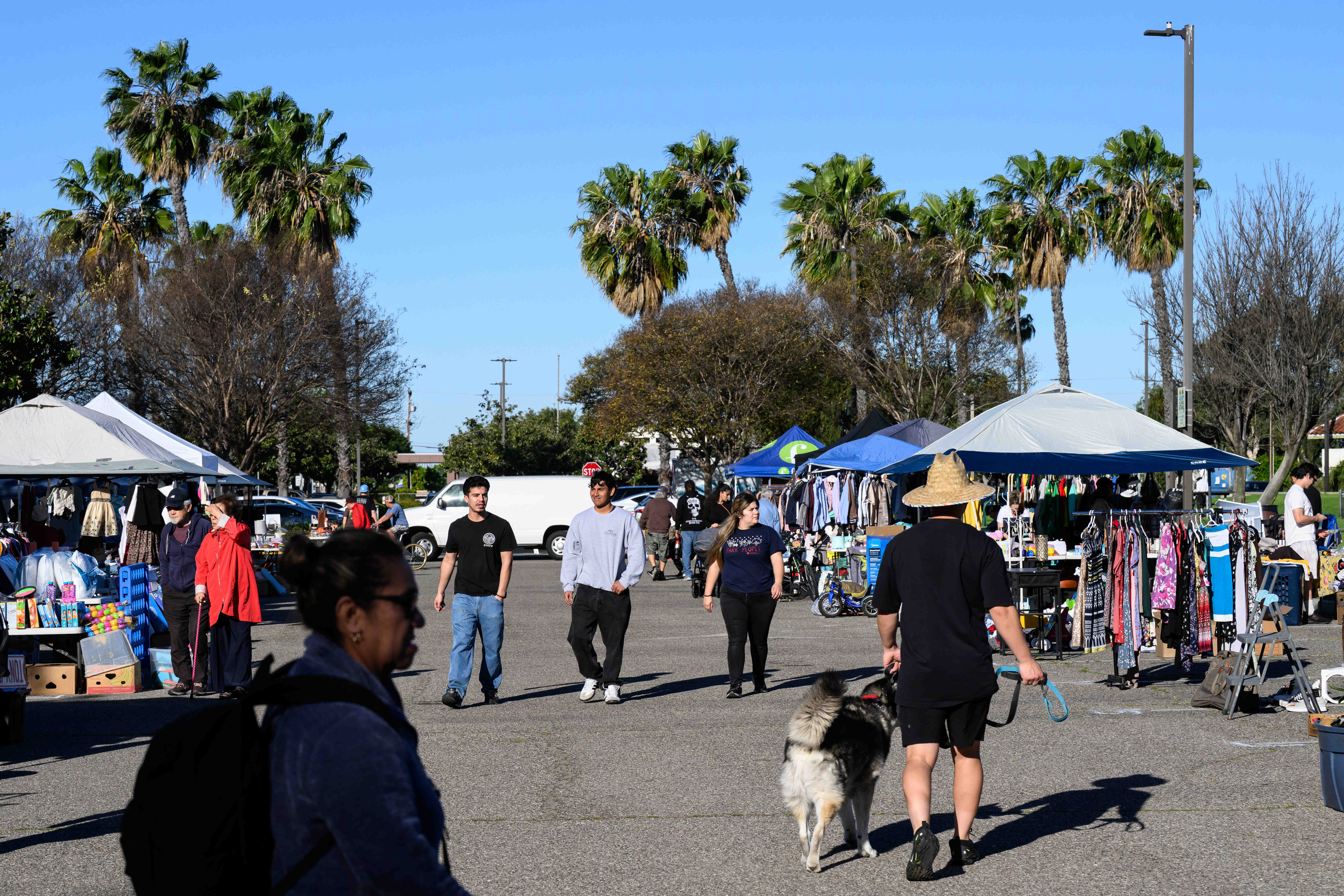 People browse during a community yard sale held by the...