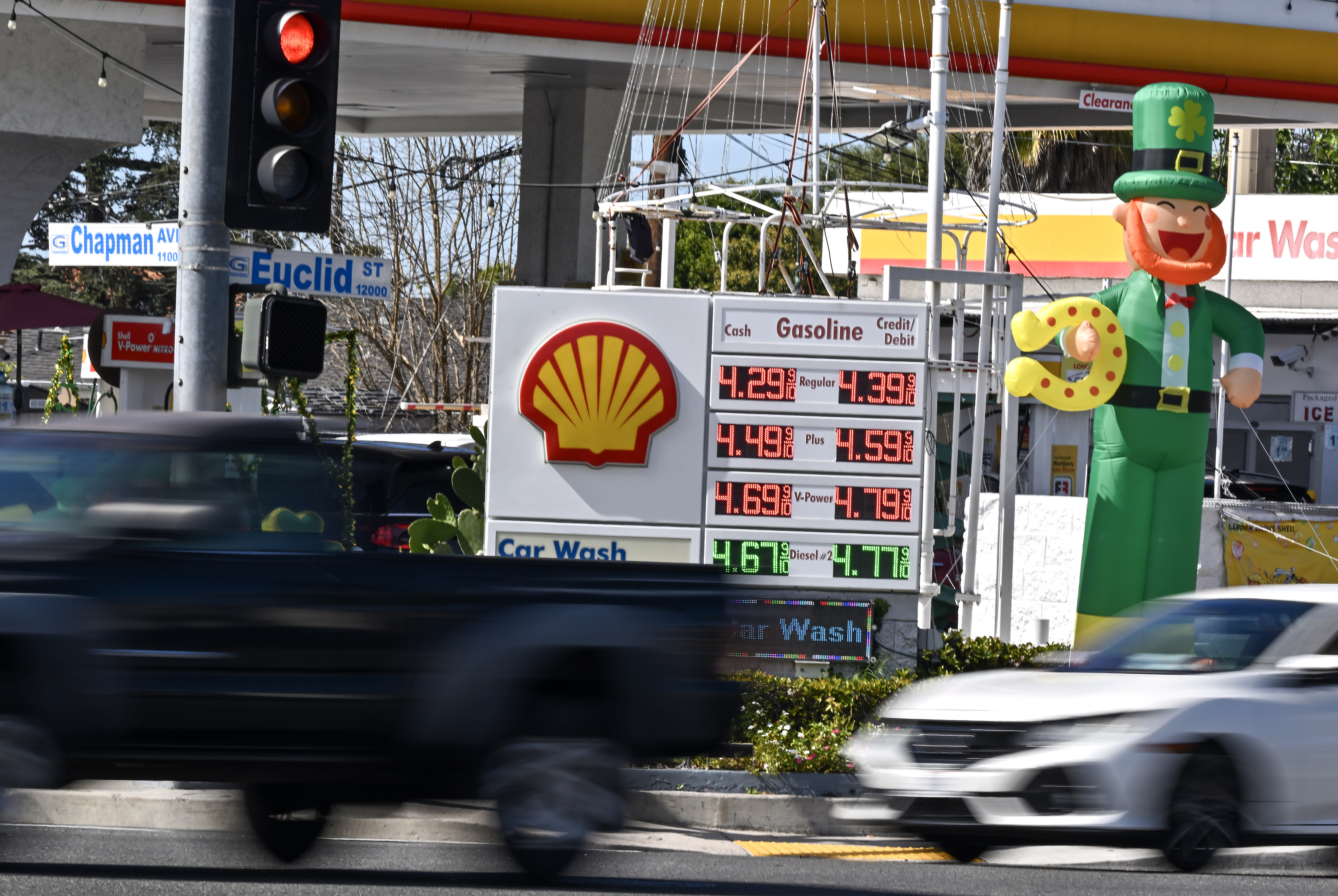 Festive St. Patrickâs Day decorations surround gas prices at a...