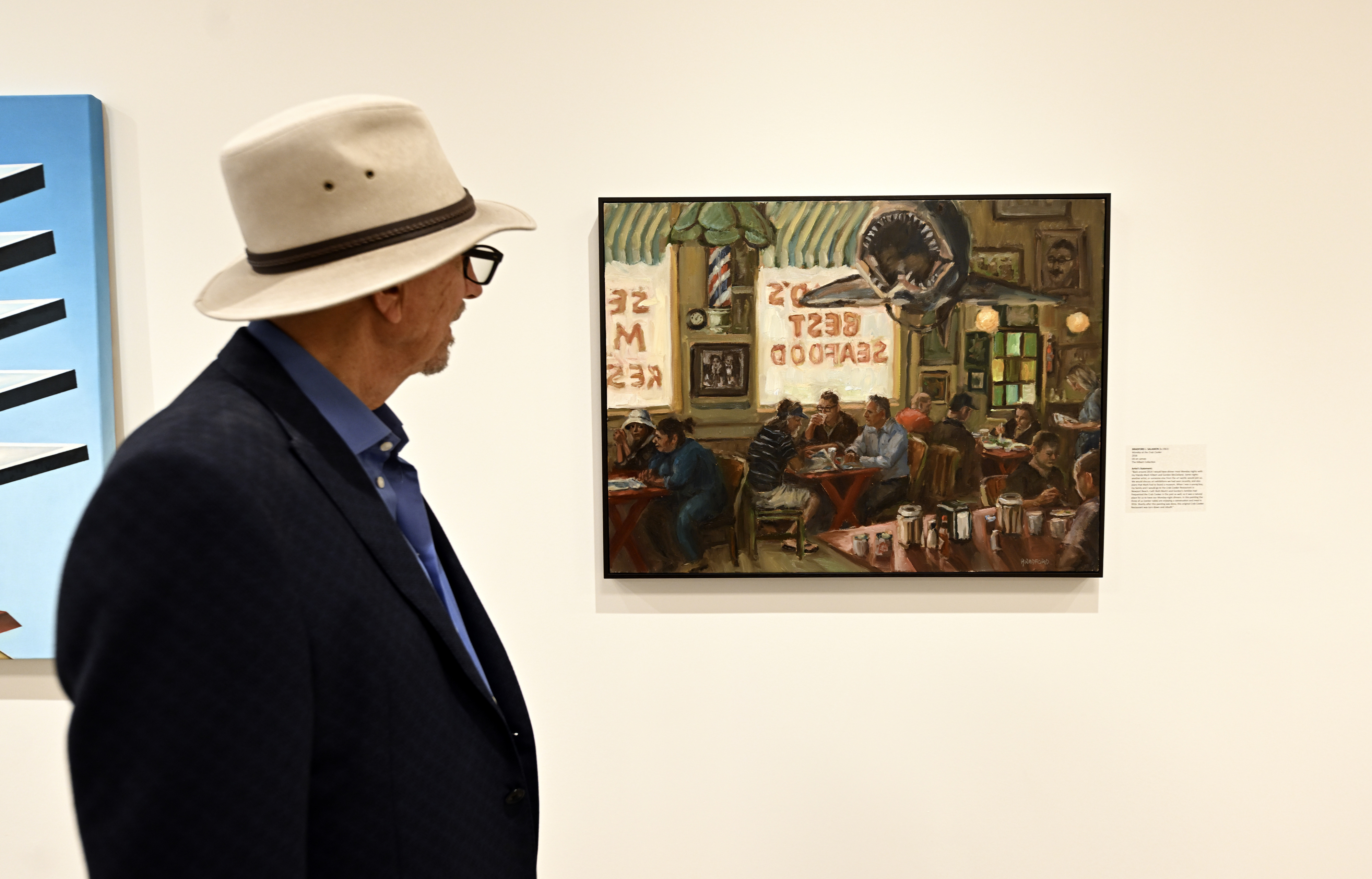Mark Hilbert with the painting, âMonday at the Crab Cookerâ...