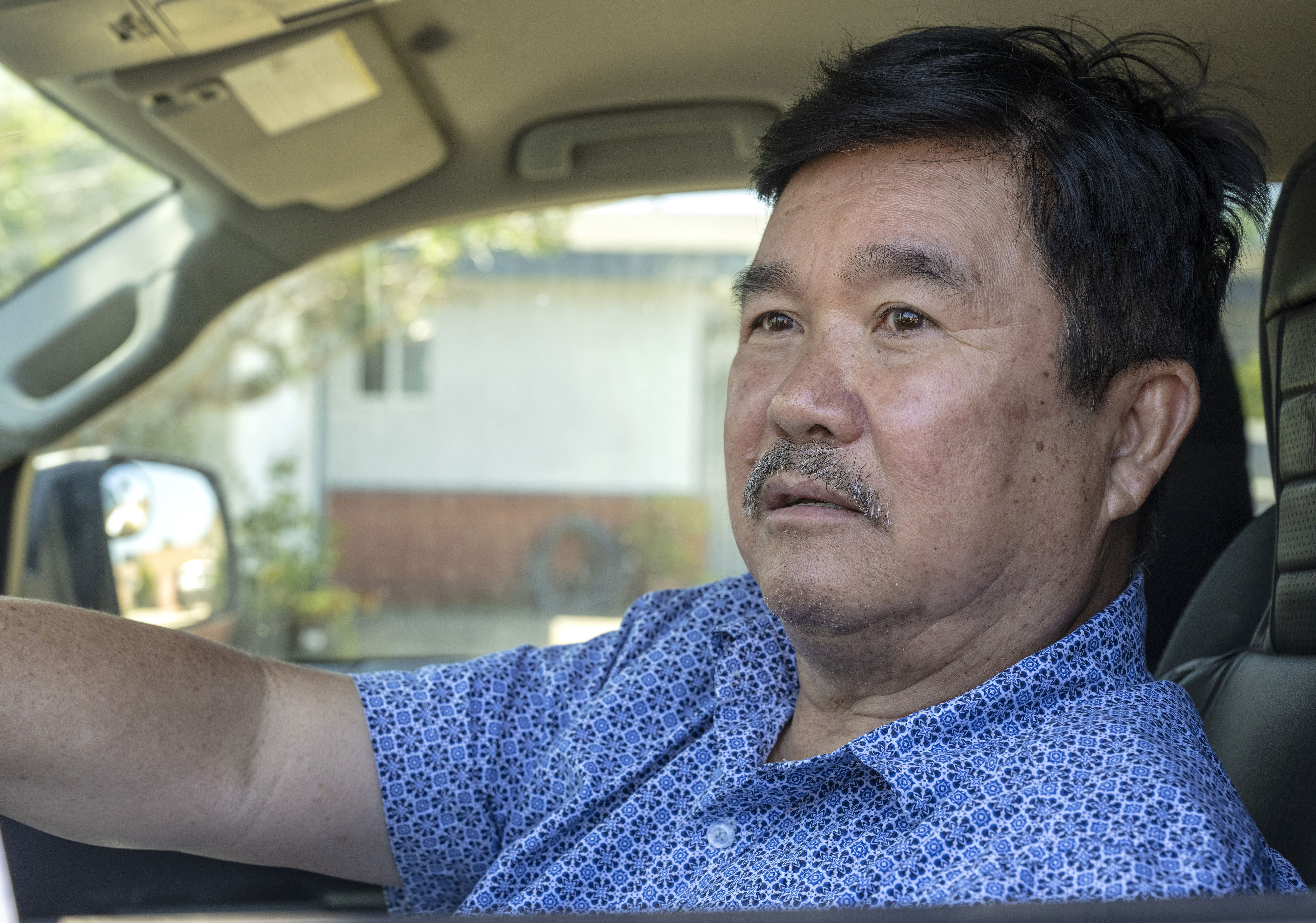 Viet America Society President Peter Pham sits in his truck...