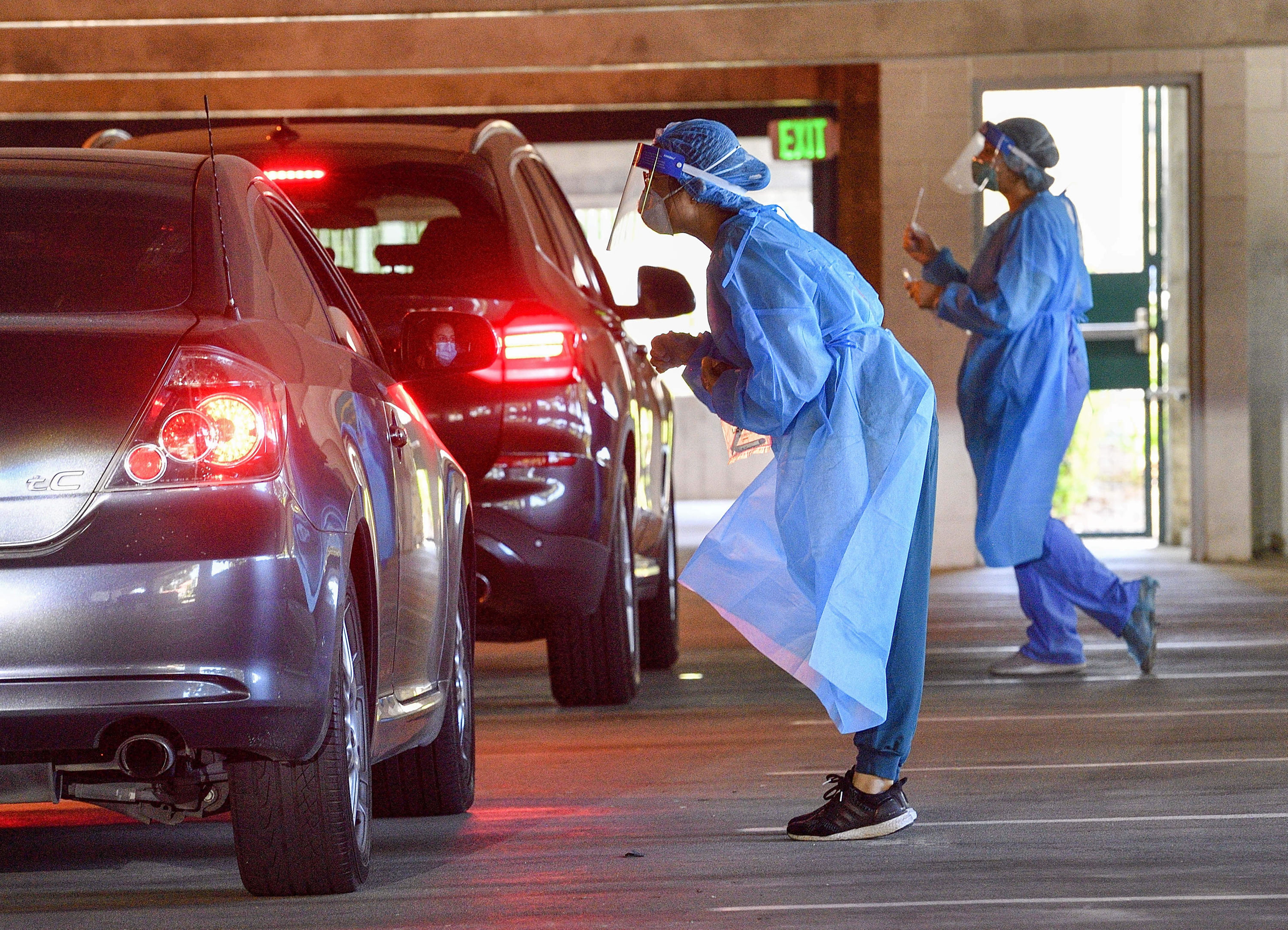 In this 2020 file photo, 360 Clinic workers give COVID...