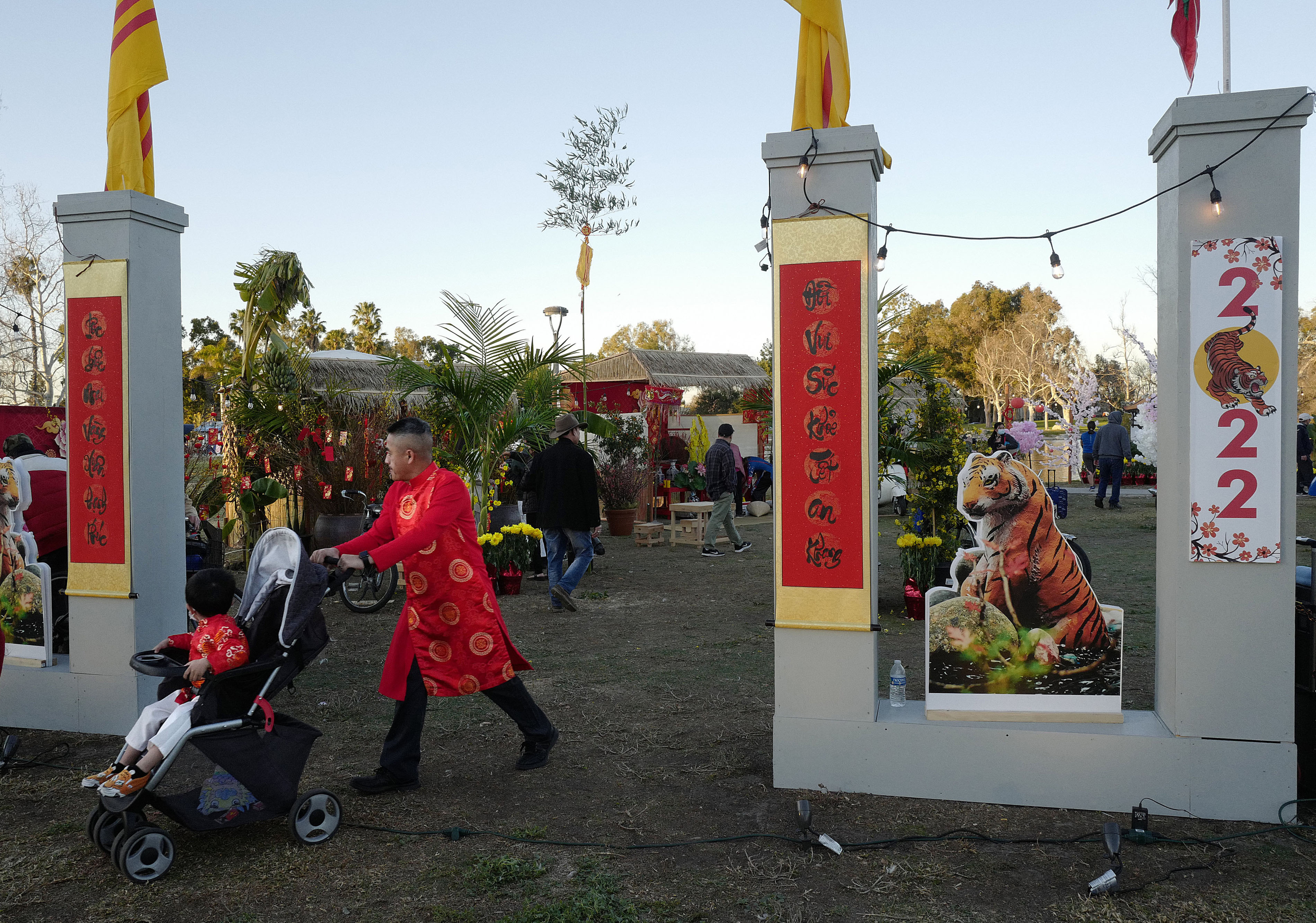 A man exits a little replica Vietnamese town with a...